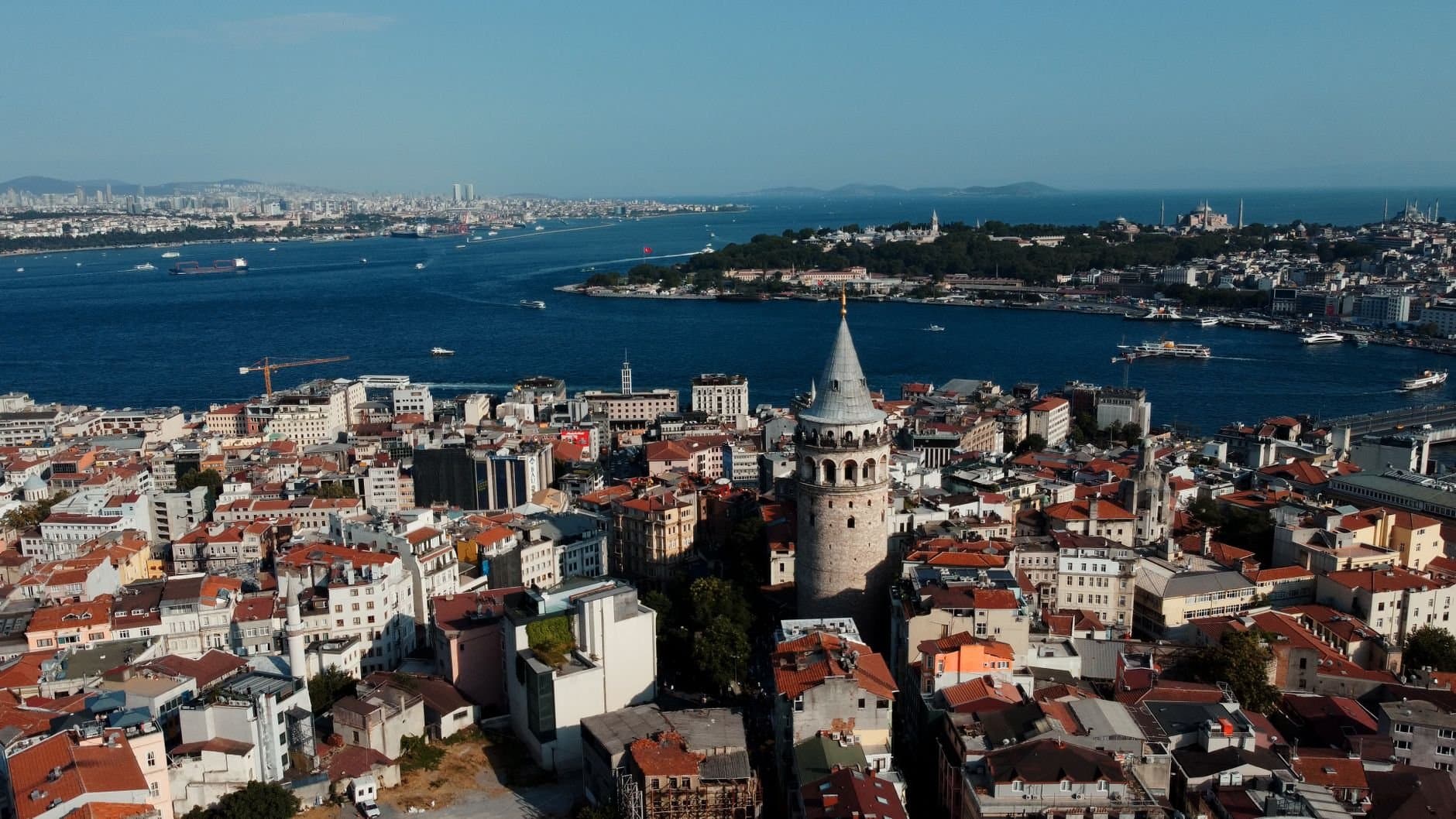 Panoramic aerial view of Galata Tower in Istanbul, showcasing the city's skyline and Bosphorus.