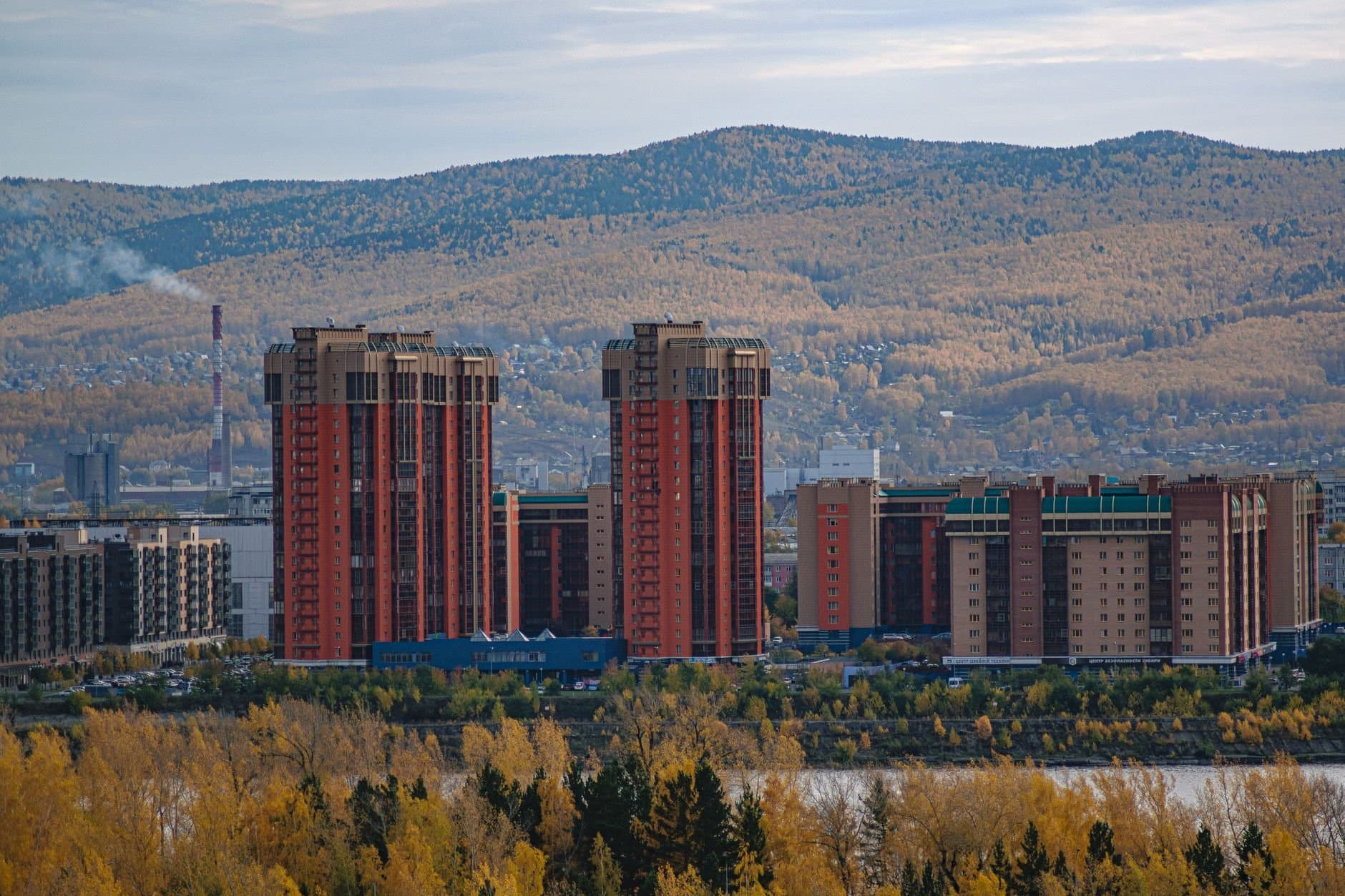 A stunning view of Krasnoyarsk cityscape featuring modern skyscrapers along the Yenisei River.