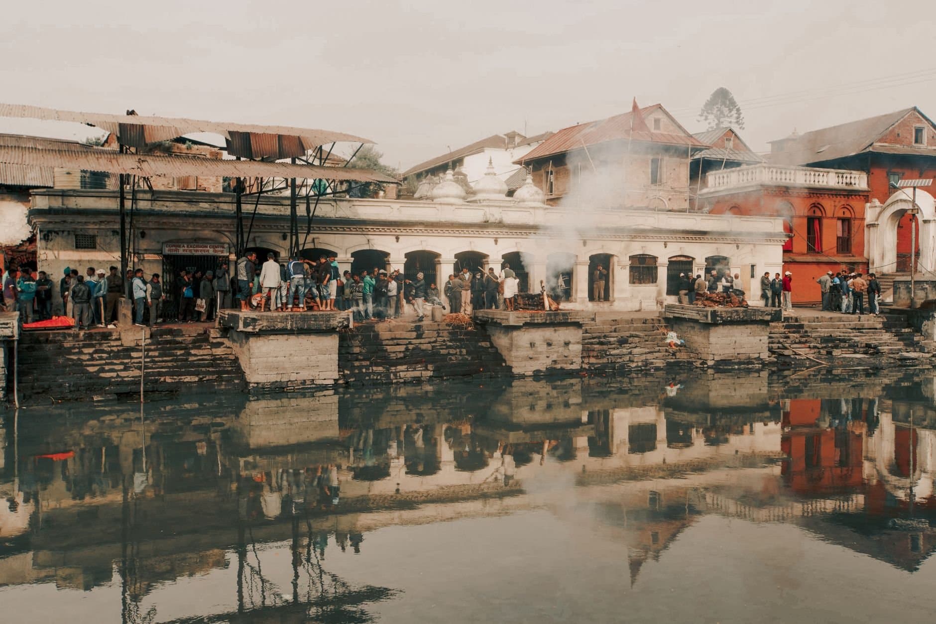 Cremation ceremonies at Pashupatinath Temple, Kathmandu, a sacred Hindu site by the Bagmati River.