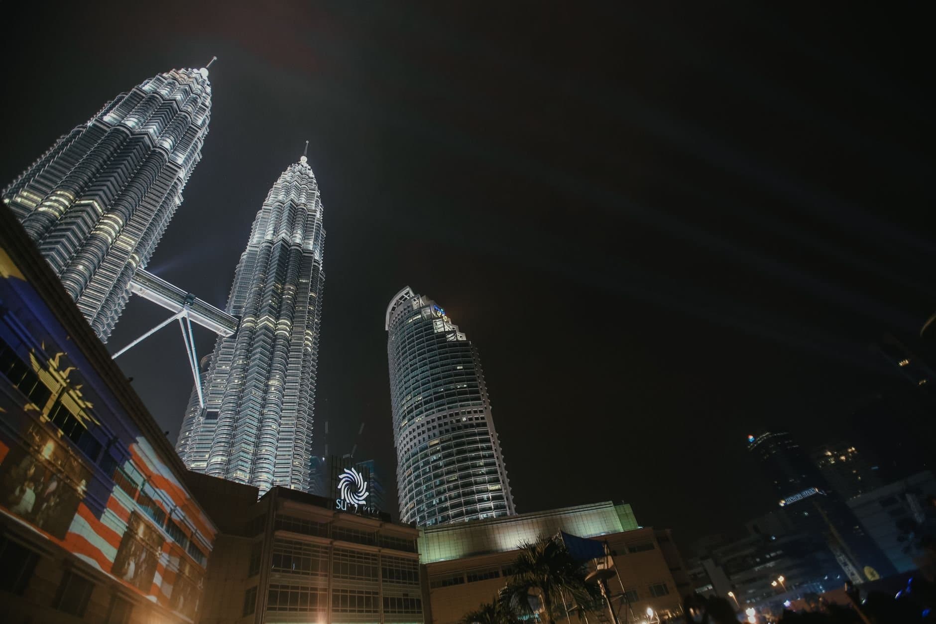 A stunning nighttime view of the Petronas Twin Towers illuminated in Kuala Lumpur, Malaysia.