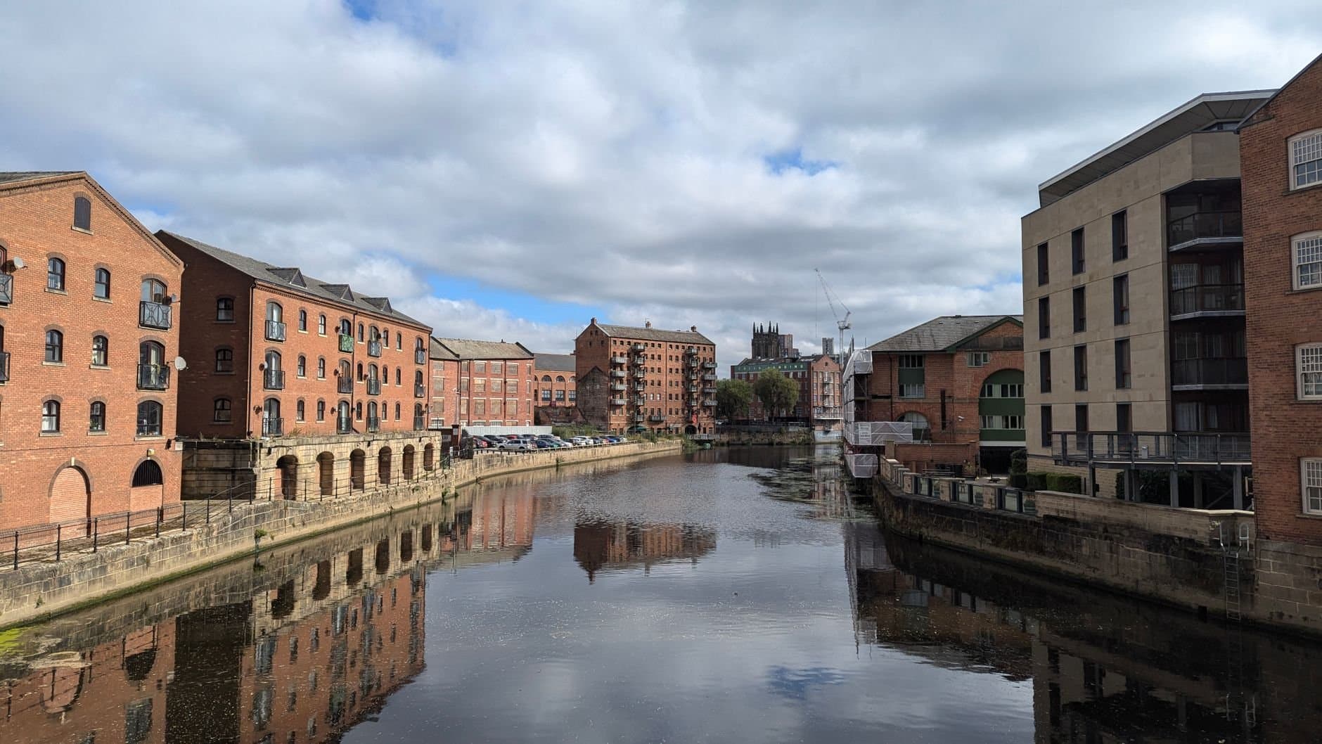 Scenic view of Leeds waterfront featuring historic architecture along the river.