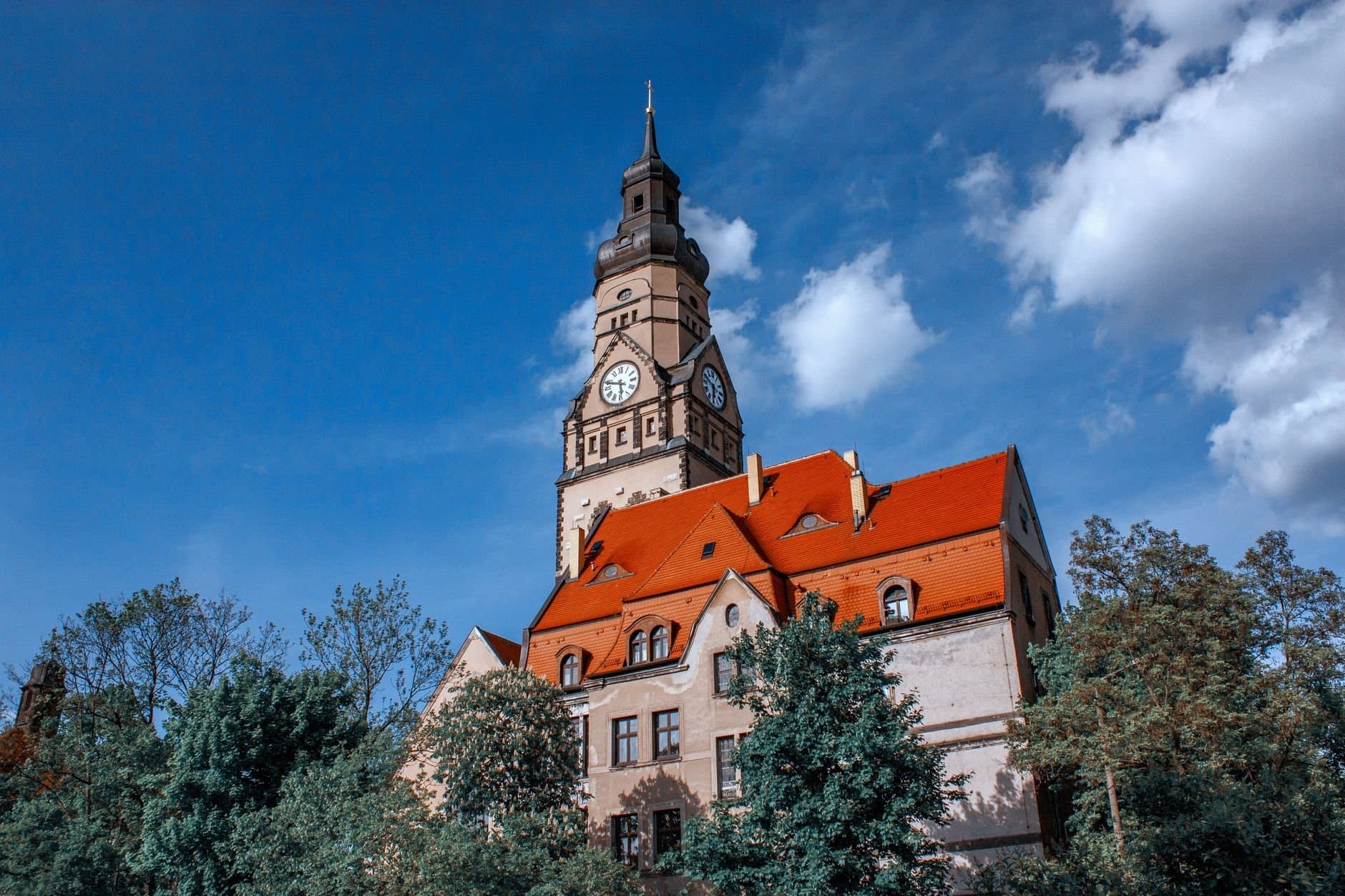 Majestic gothic clock tower in Leipzig with vibrant architecture and scenic surroundings.