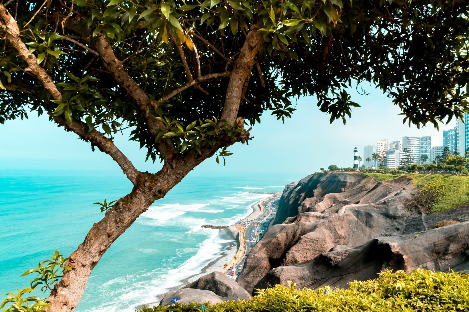Beautiful view of Lima's coastline merging with the urban skyline and lush greenery.