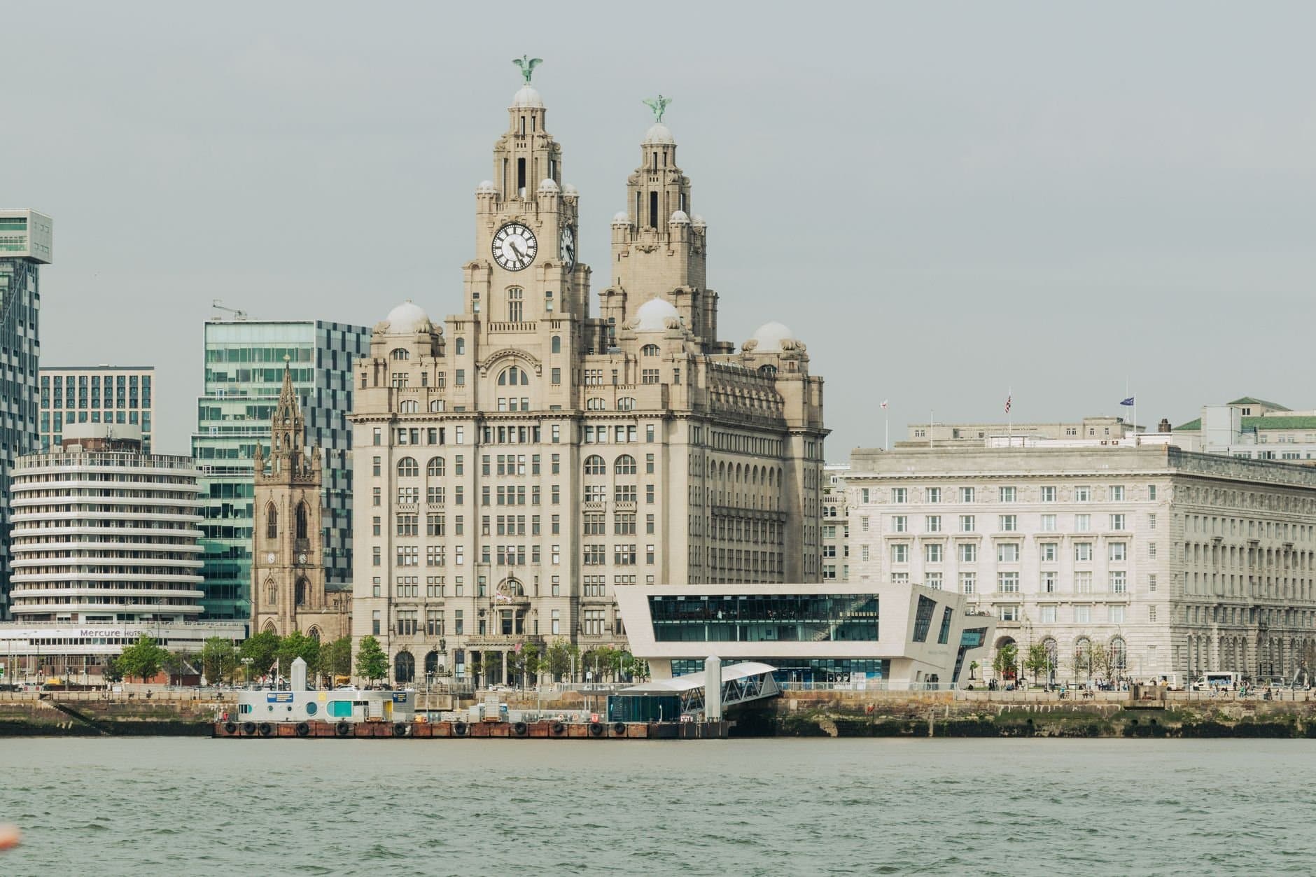 Scenic view of Liverpool's Royal Liver Building at the waterfront, showcasing architectural elegance.
