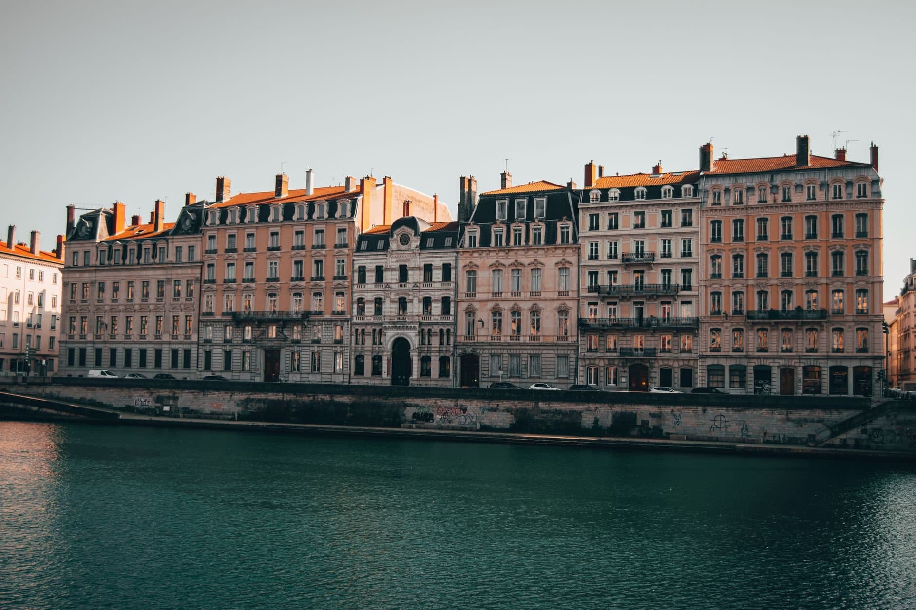 Charming view of historic buildings lining the Rhône River in Lyon, France.