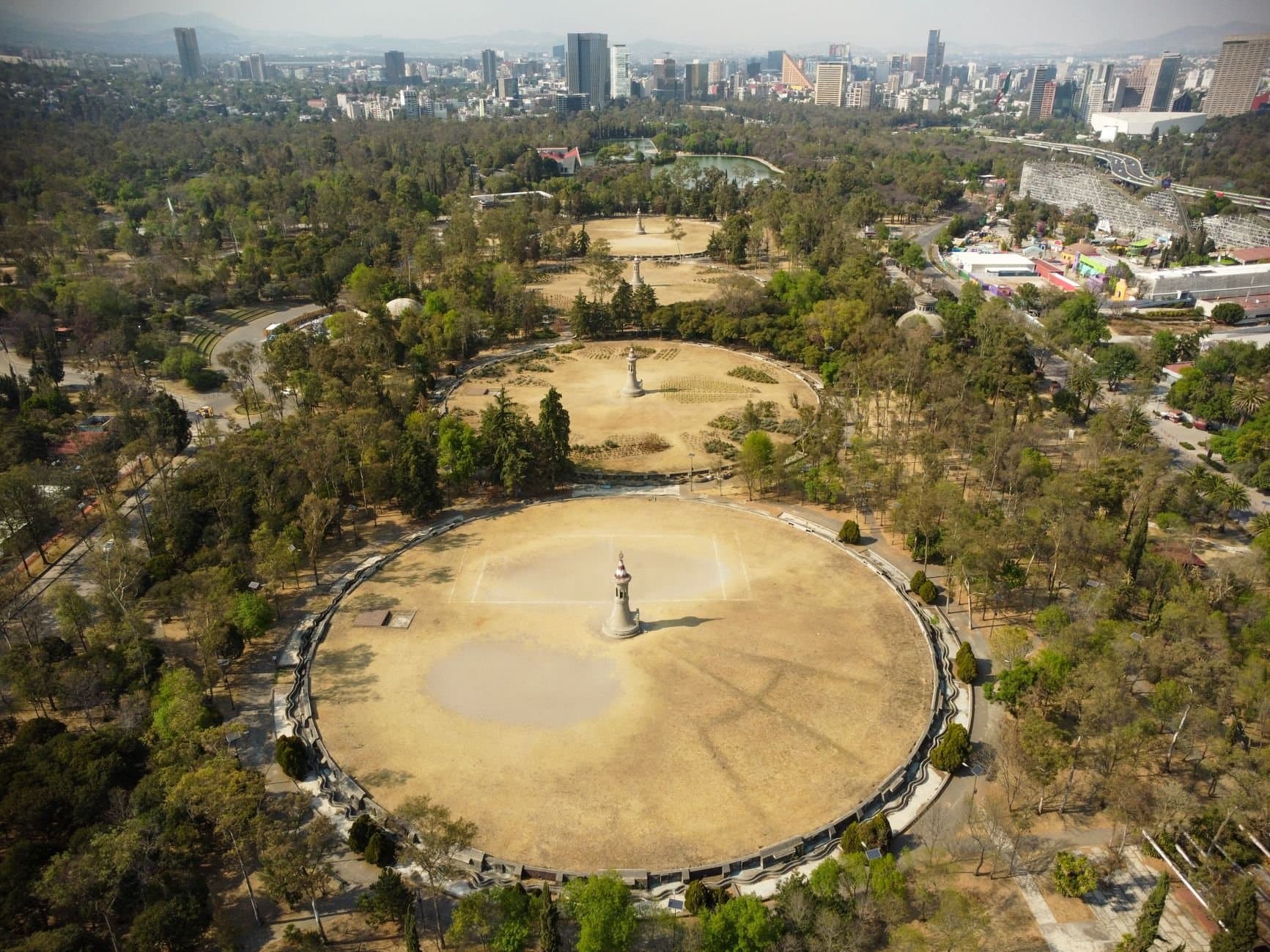 Scenic aerial view of Chapultepec Park and Mexico City skyline on a sunny day.