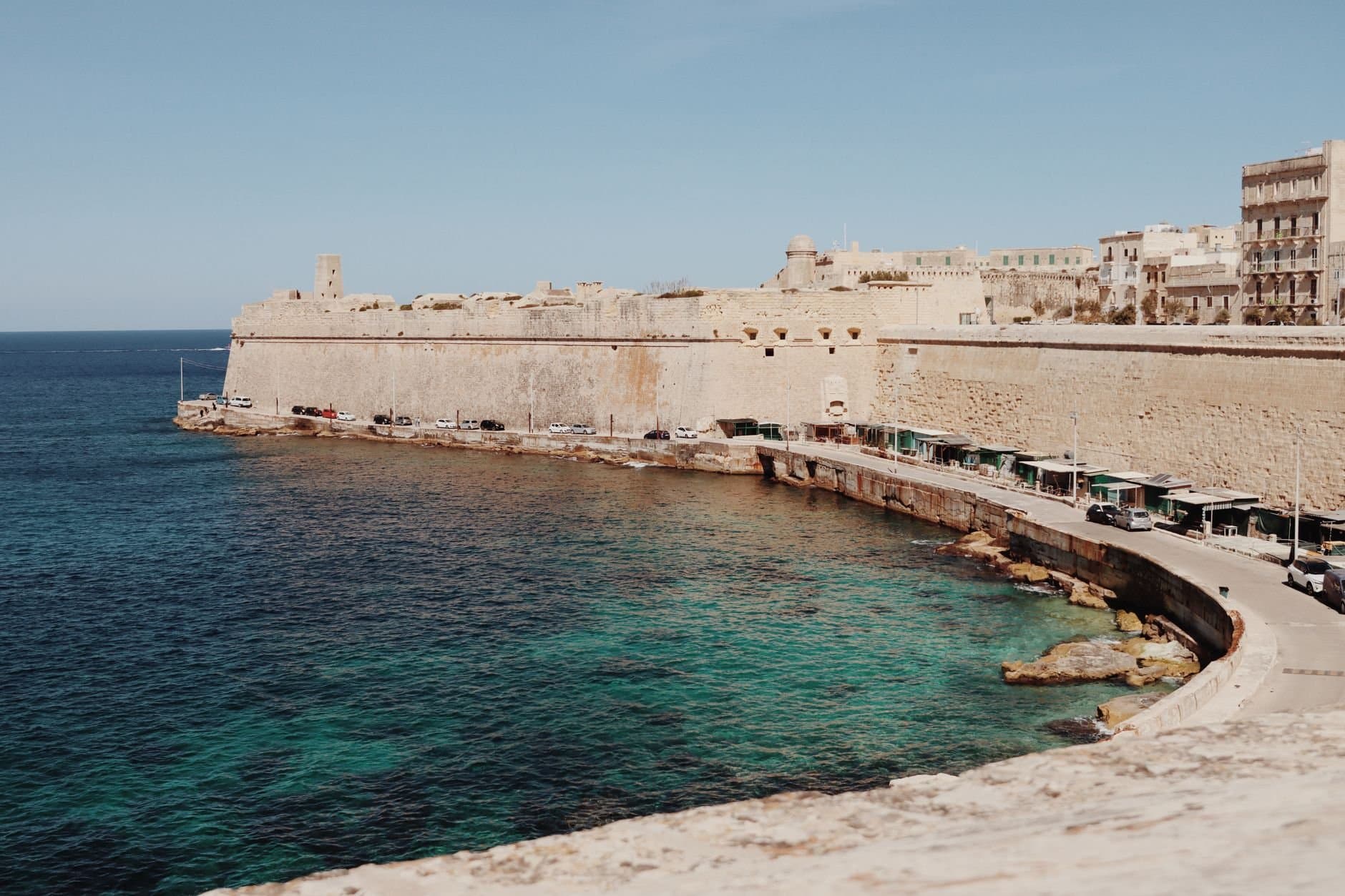 View of Valletta's historic sea fortifications and coastline in Malta, showcasing rugged charm.