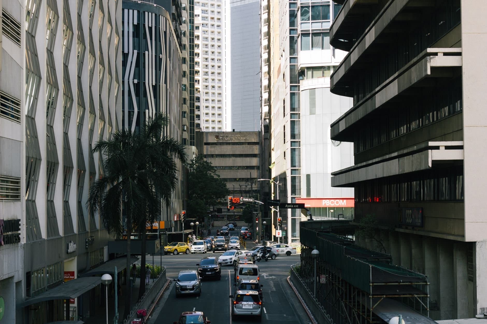 View of traffic and skyscrapers on Ayala Avenue, Manila's bustling business district.