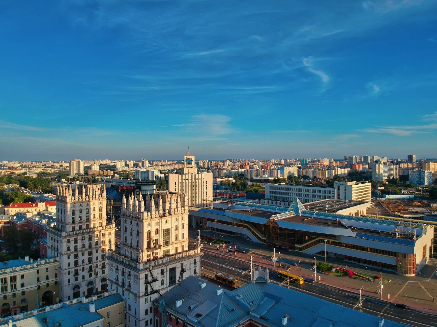 Stunning aerial view of Minsk featuring iconic buildings against a bright blue sky.