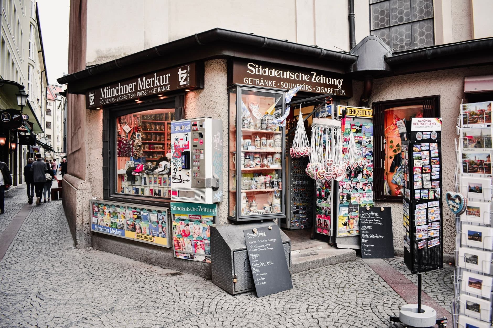 Explore the charm of Munich with this street-side kiosk in the historic Old Town, offering souvenirs and local delights.