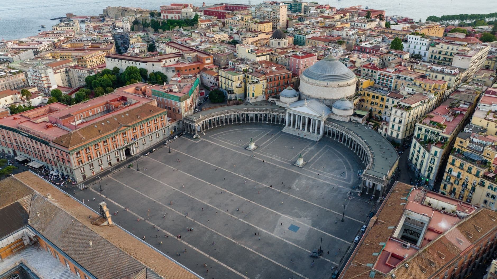 Aerial view of historic Piazza del Plebiscito in Naples, Italy with architectural landmarks.