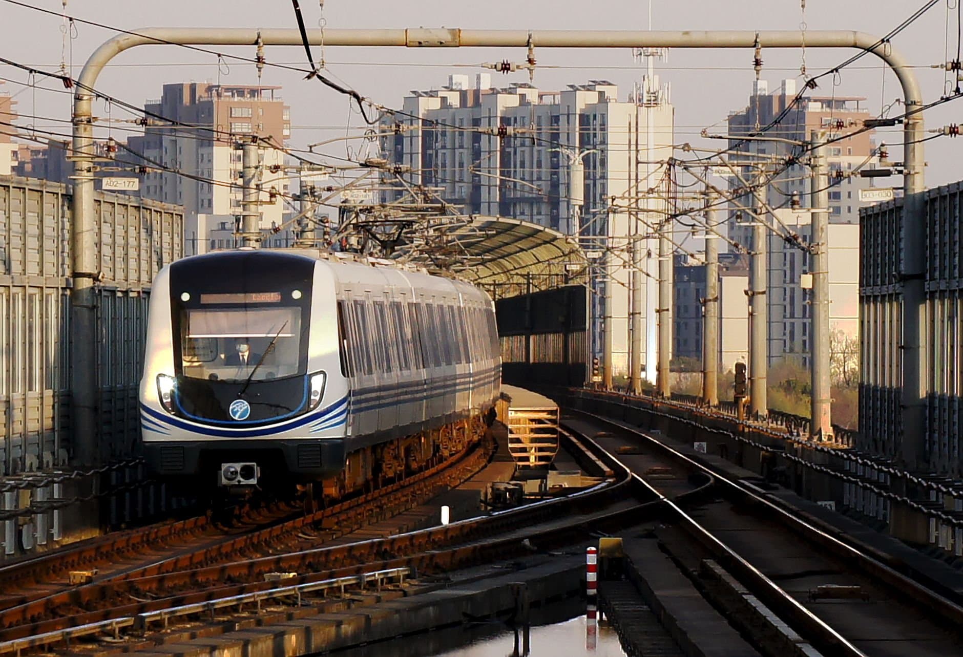 A modern train travels through urban Ningbo, showcasing advanced public transportation.