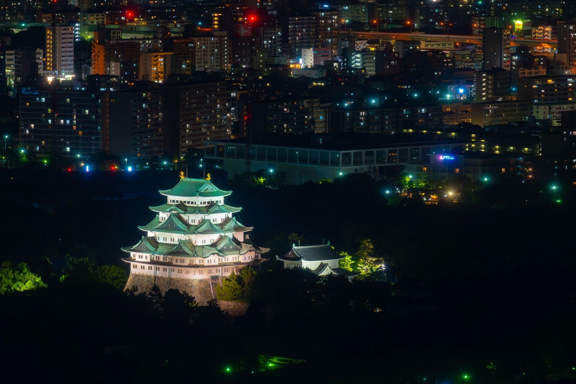 Nagoya Castle glowing amidst the city lights of Nagoya, Japan, captured at night.