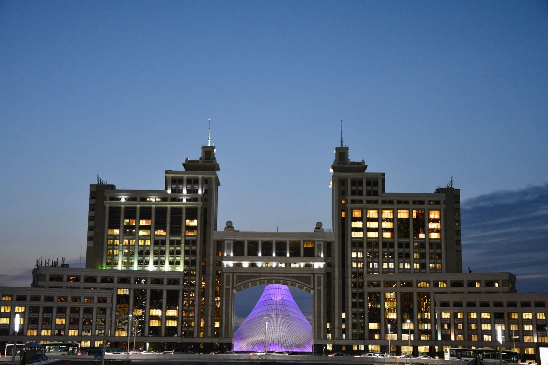 Majestic view of Astana's iconic architecture glowing against evening sky.