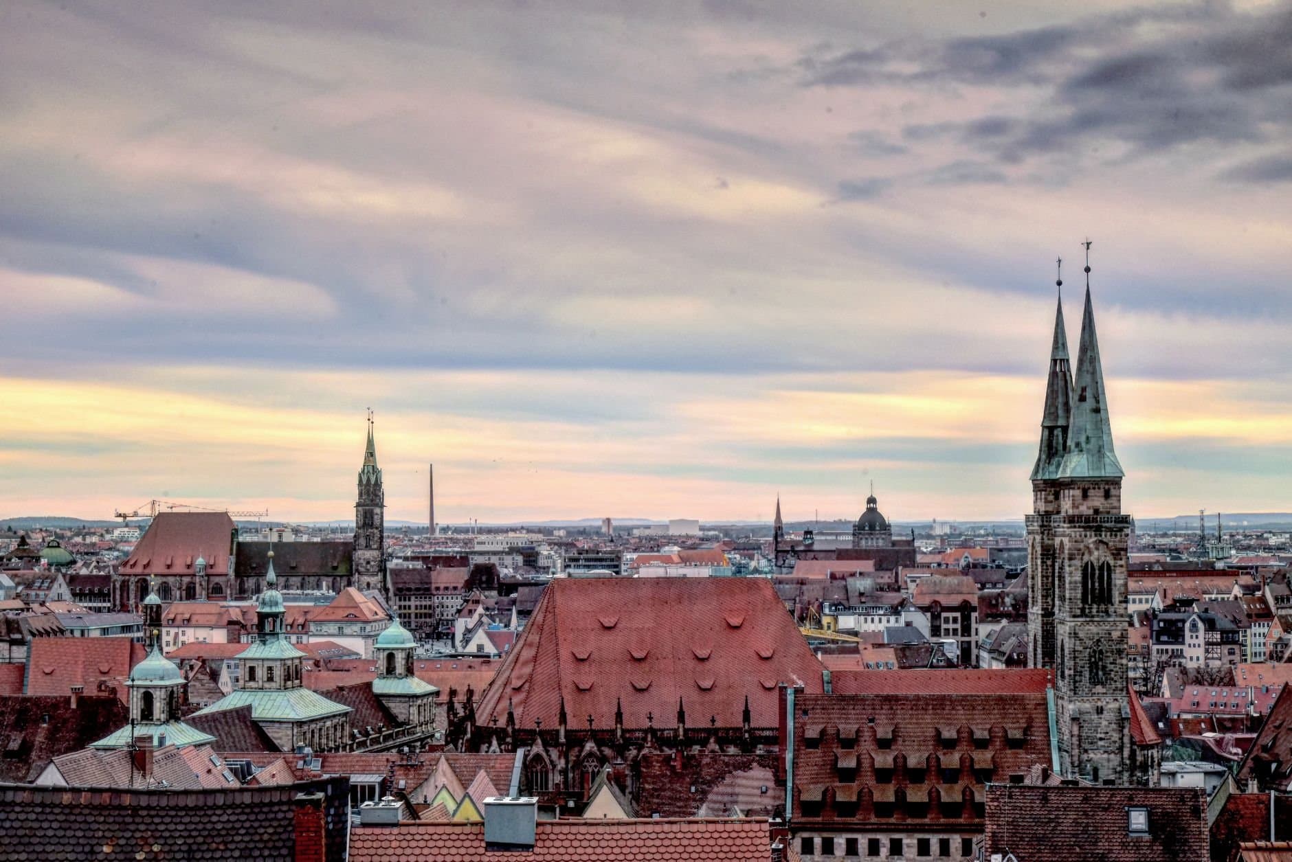 A stunning view of Nuremberg's historic skyline with iconic church towers and a vibrant sky.