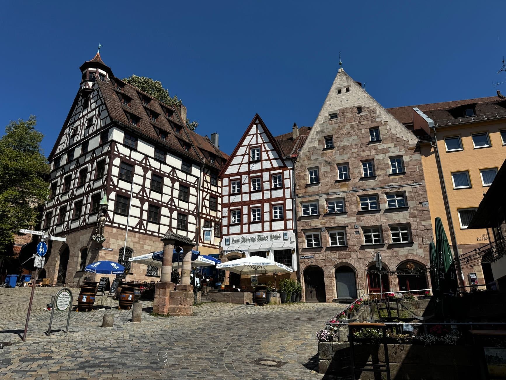 Historic half-timbered buildings in Nuremberg's old town under clear blue skies, capturing medieval charm.