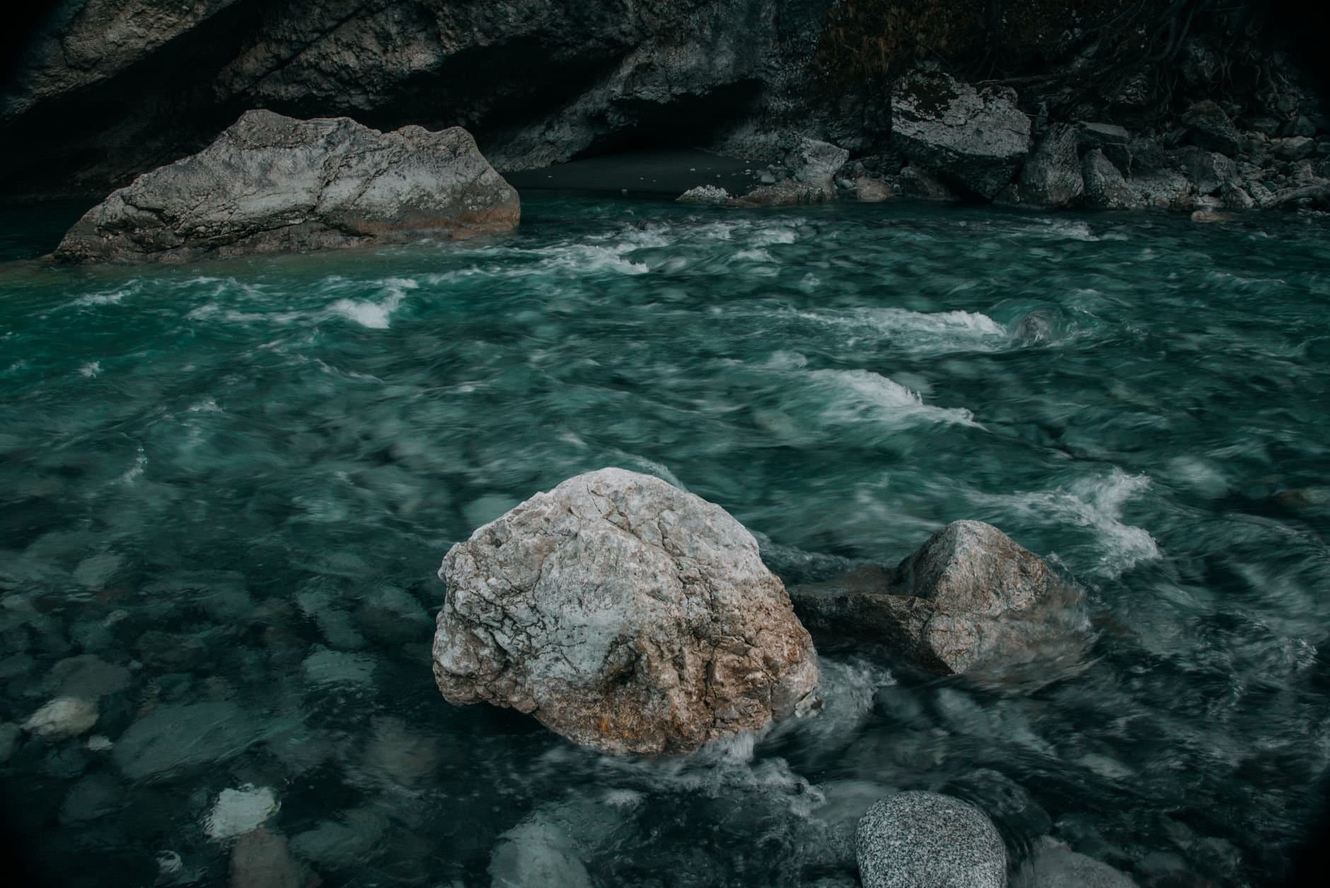Serene mountain stream flowing over rocks in North Ossetia's picturesque landscape.
