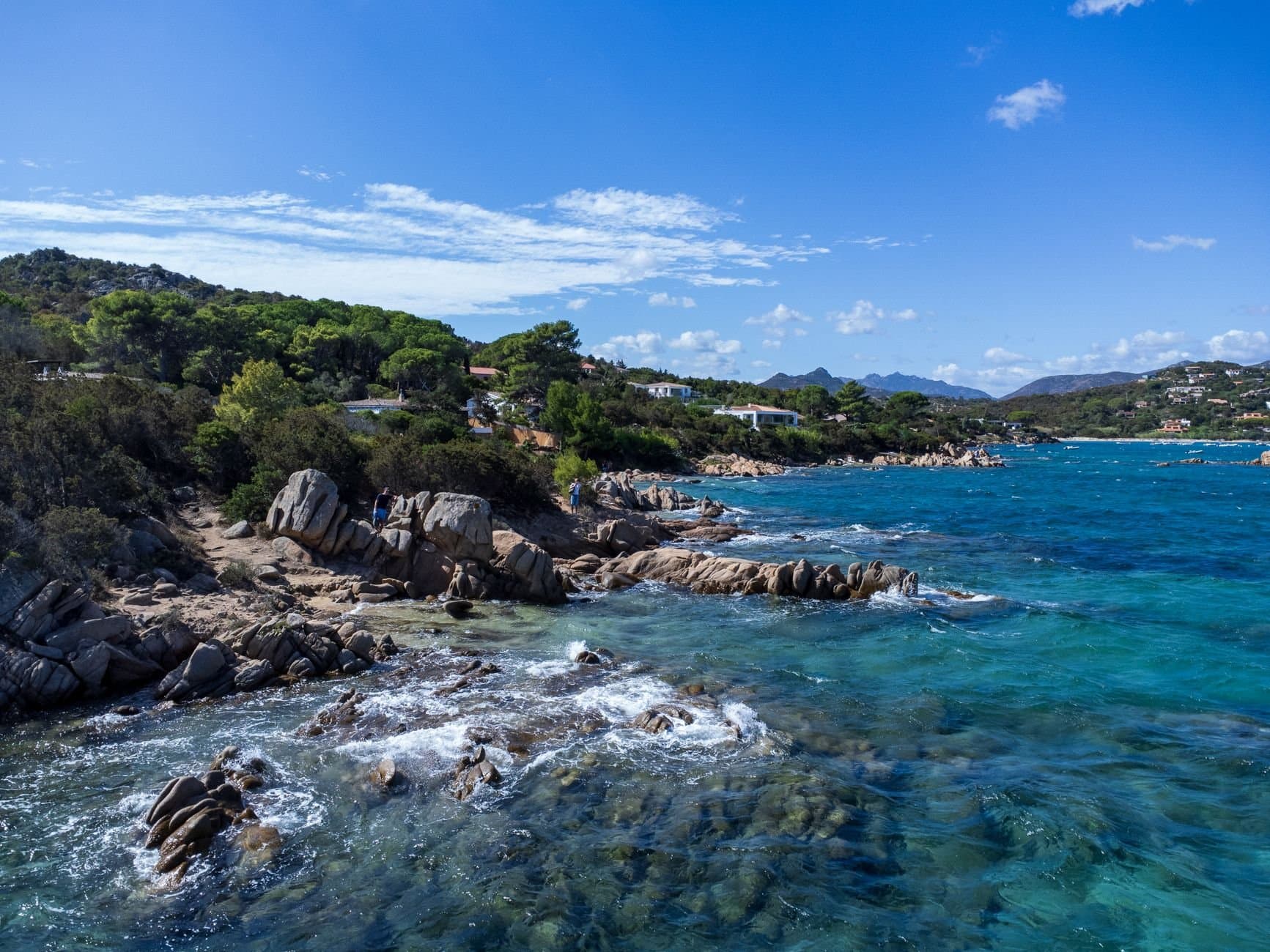 Stunning coastal landscape in Sardinia, Italy with turquoise waters and rocky shoreline.