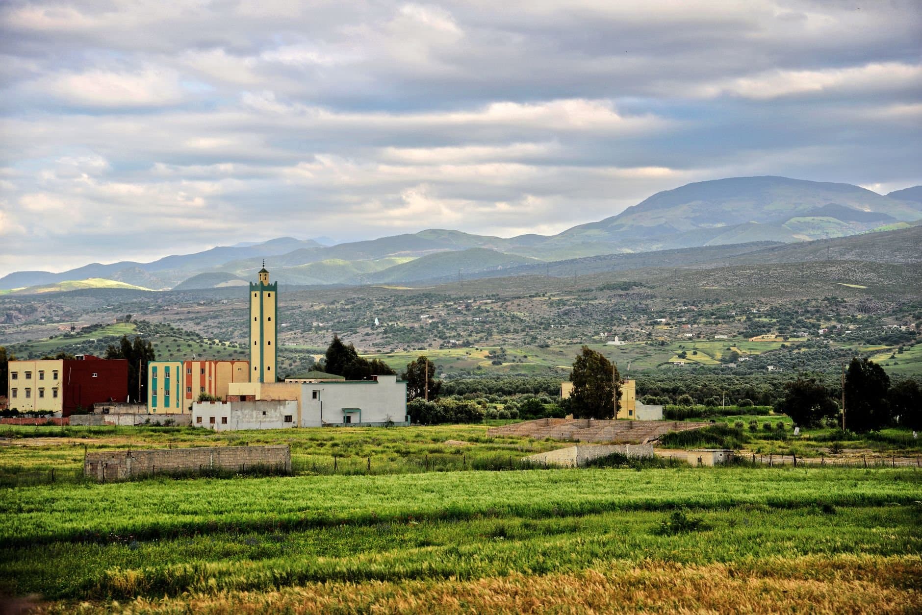 Picturesque landscape in Taza, Morocco featuring mosque and lush scenery.