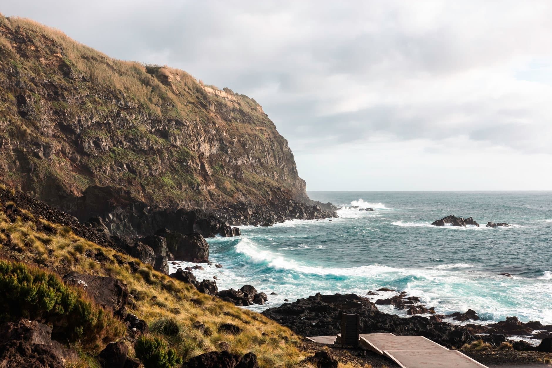 Stunning view of São Miguel Island cliffs with crashing waves along the rocky Azores shoreline.