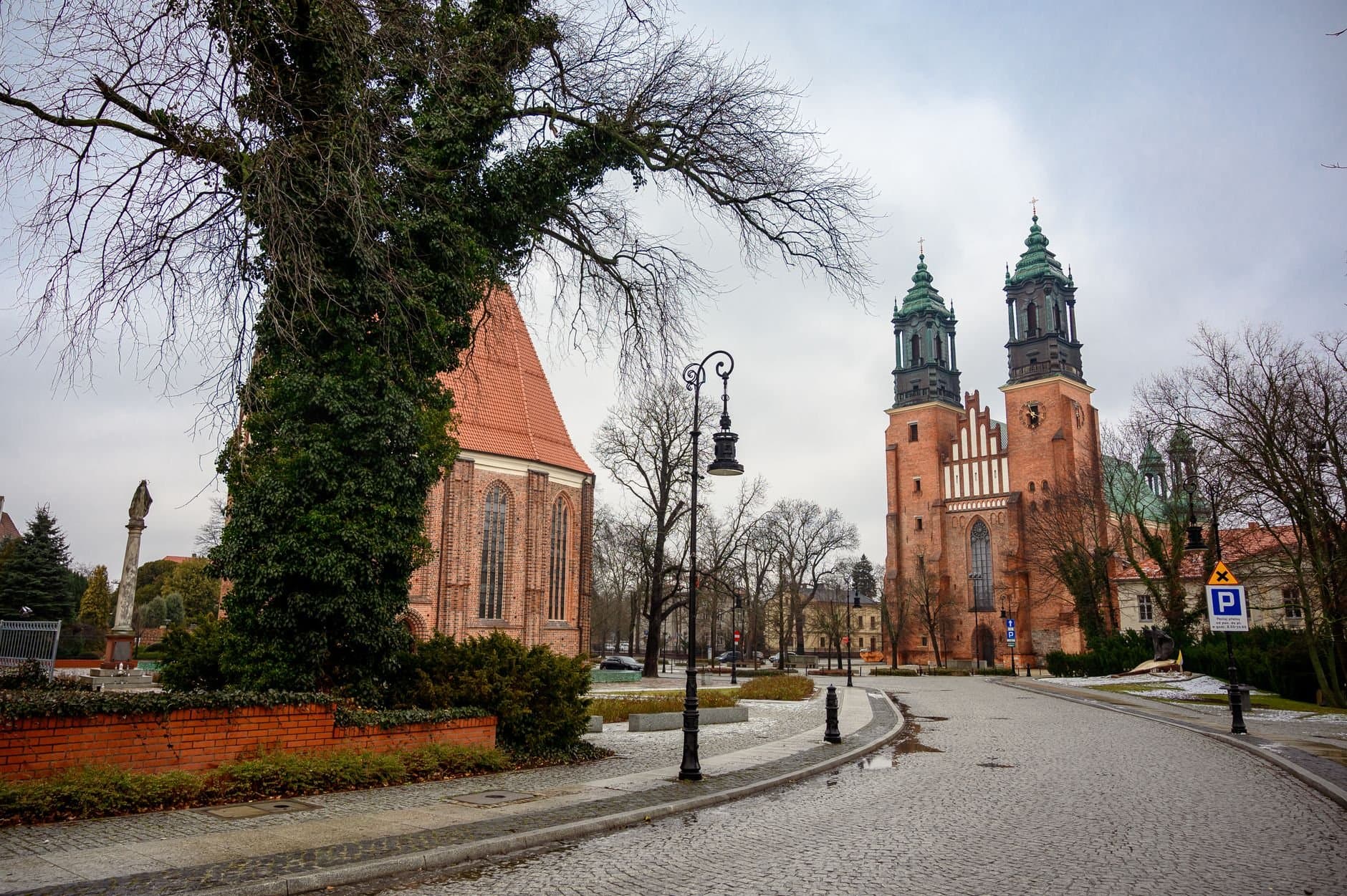 Beautiful urban scene of a cathedral in winter, showcasing striking architecture and empty cobblestone streets.