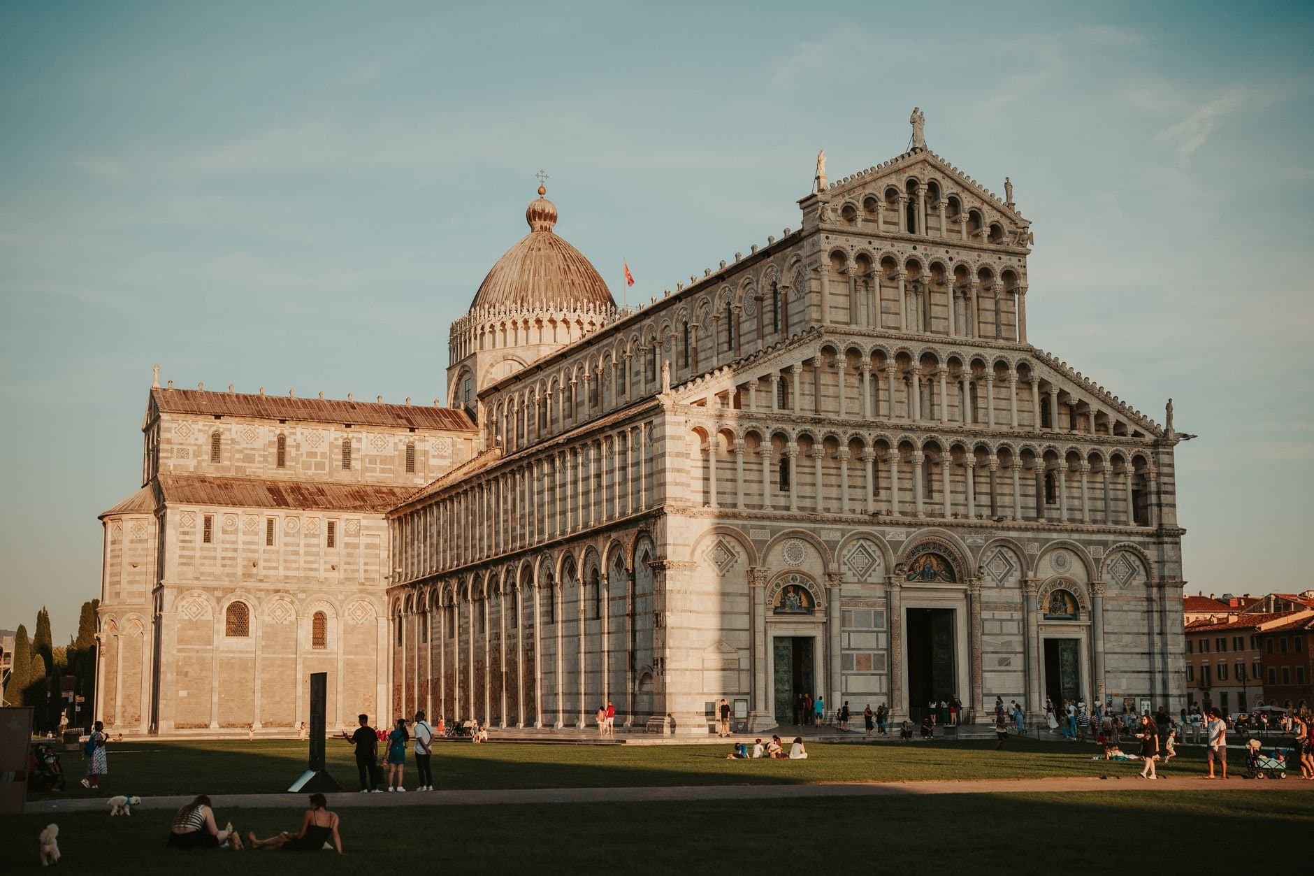 Explore the beautiful Pisa Cathedral in Italy bathed in warm daylight, showcasing its architectural grandeur.