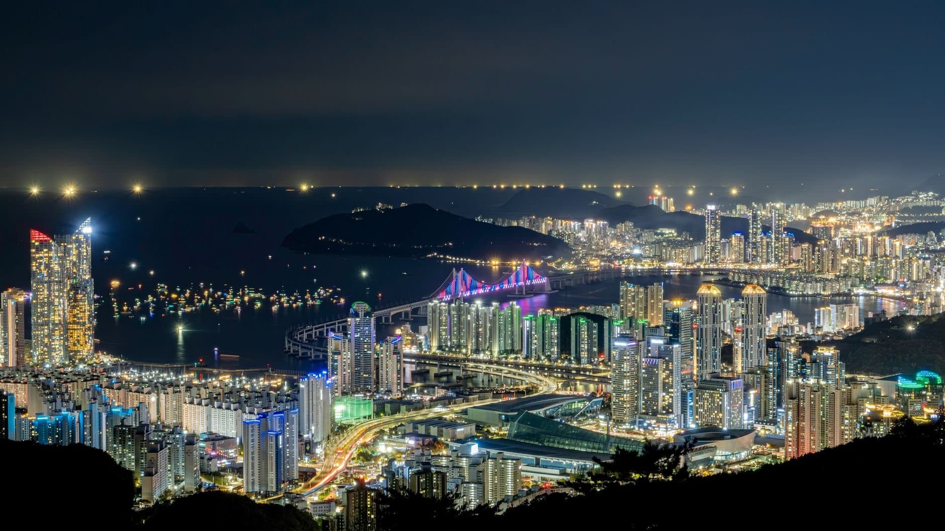 Stunning view of Busan's illuminated skyline and Gwangan Bridge at night in South Korea.