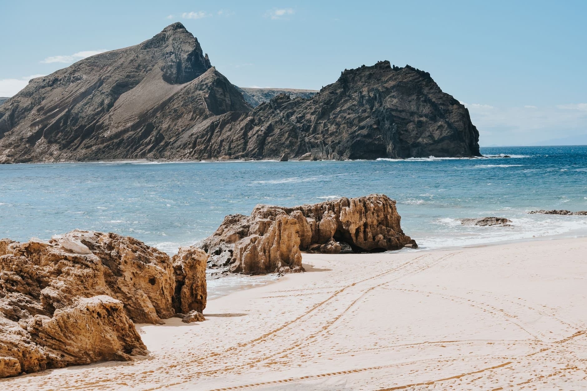 Discover the stunning rocky shores of Porto Santo, Portugal.