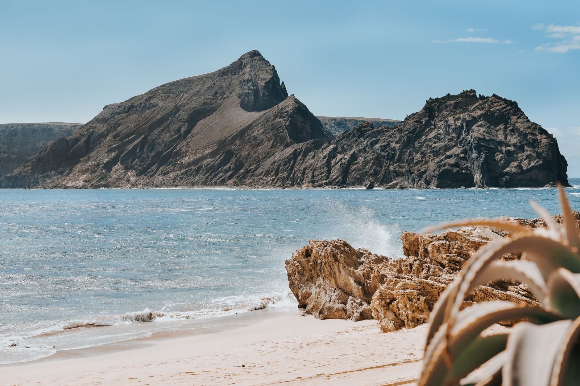 Serene beach view with rocky cliffs in Porto Santo, Madeira, Portugal.