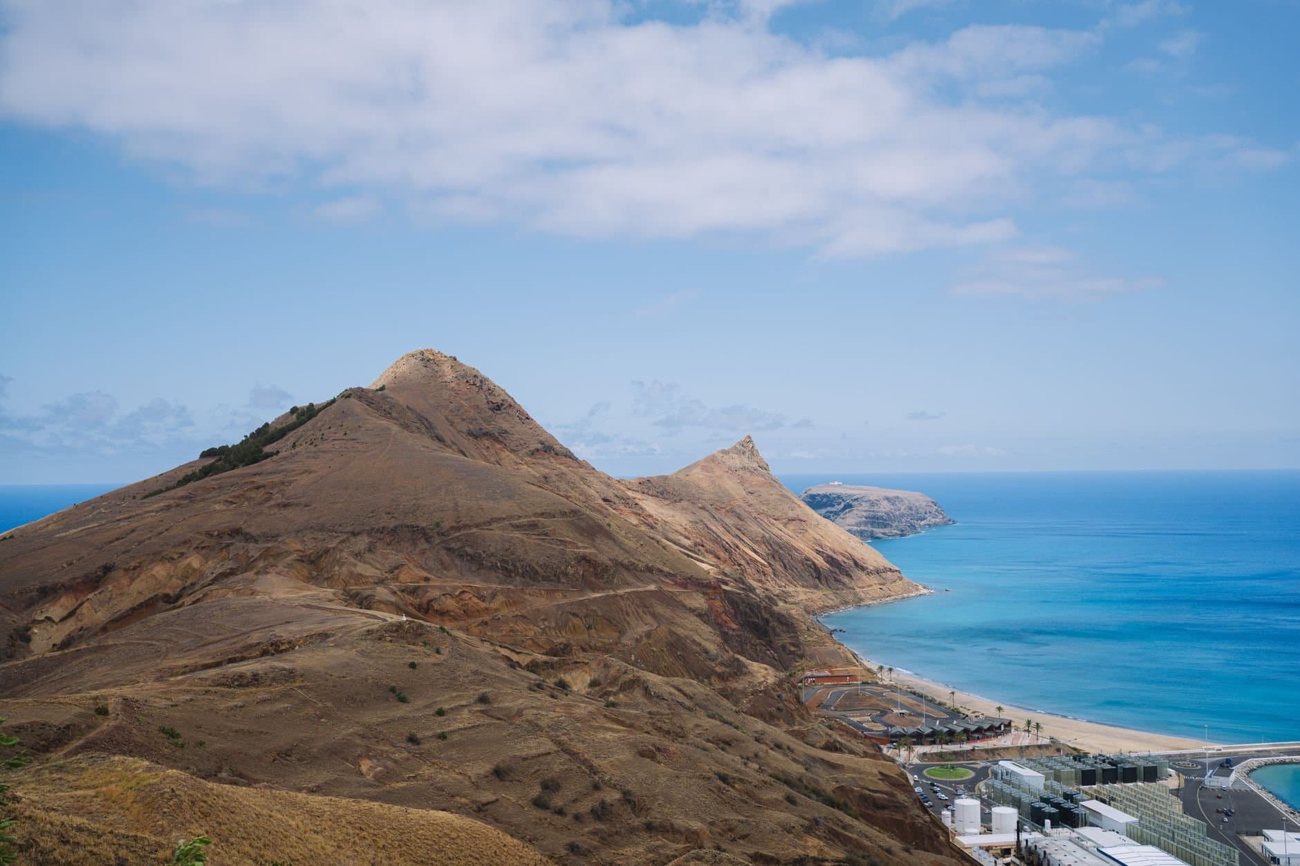 Dramatic landscape of a volcanic island with rugged cliffs overlooking the azure ocean waters, perfect for travel enthusiasts.