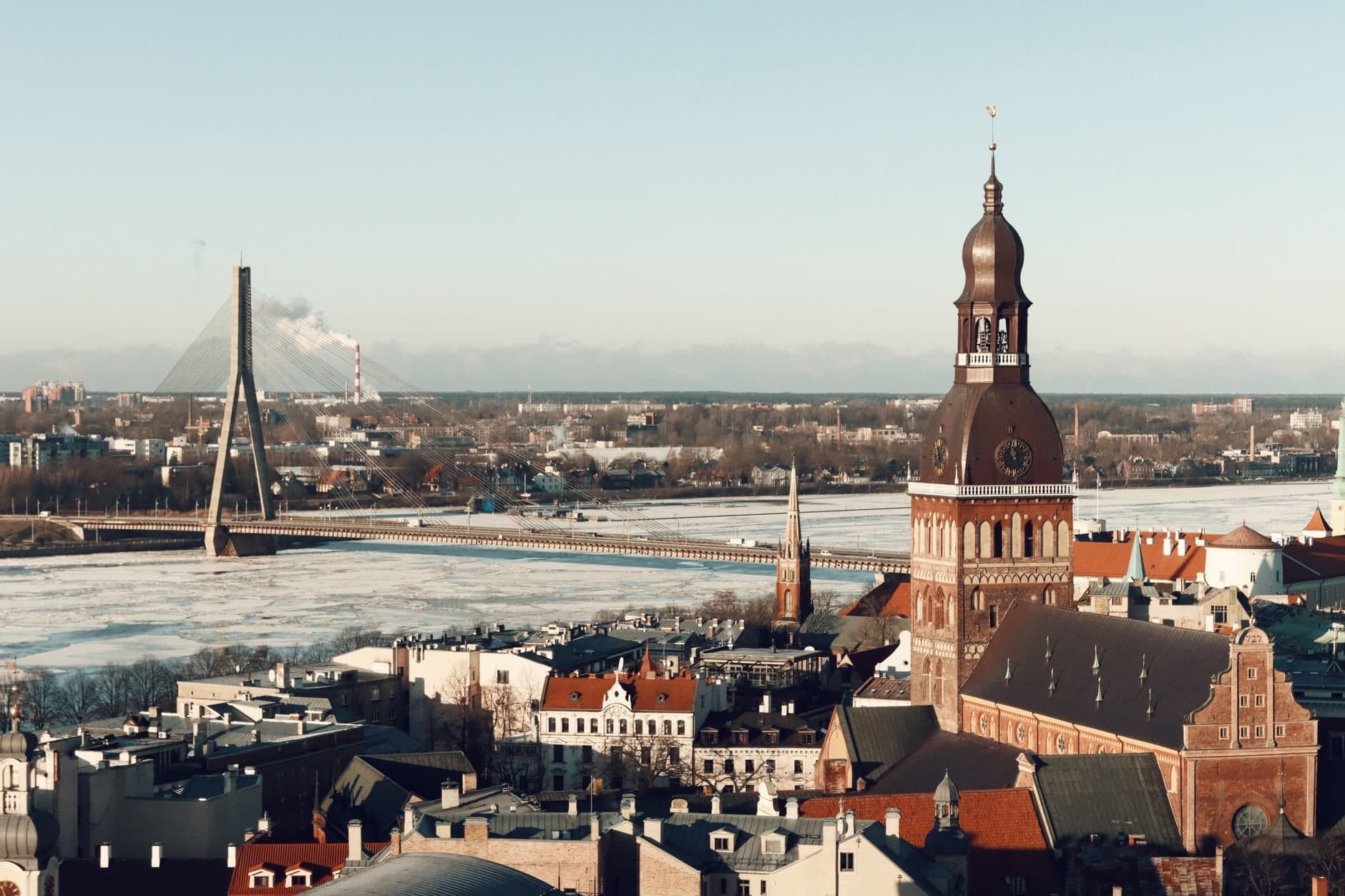 Aerial view of Riga, Latvia showcasing its iconic bridge and cathedral in winter.