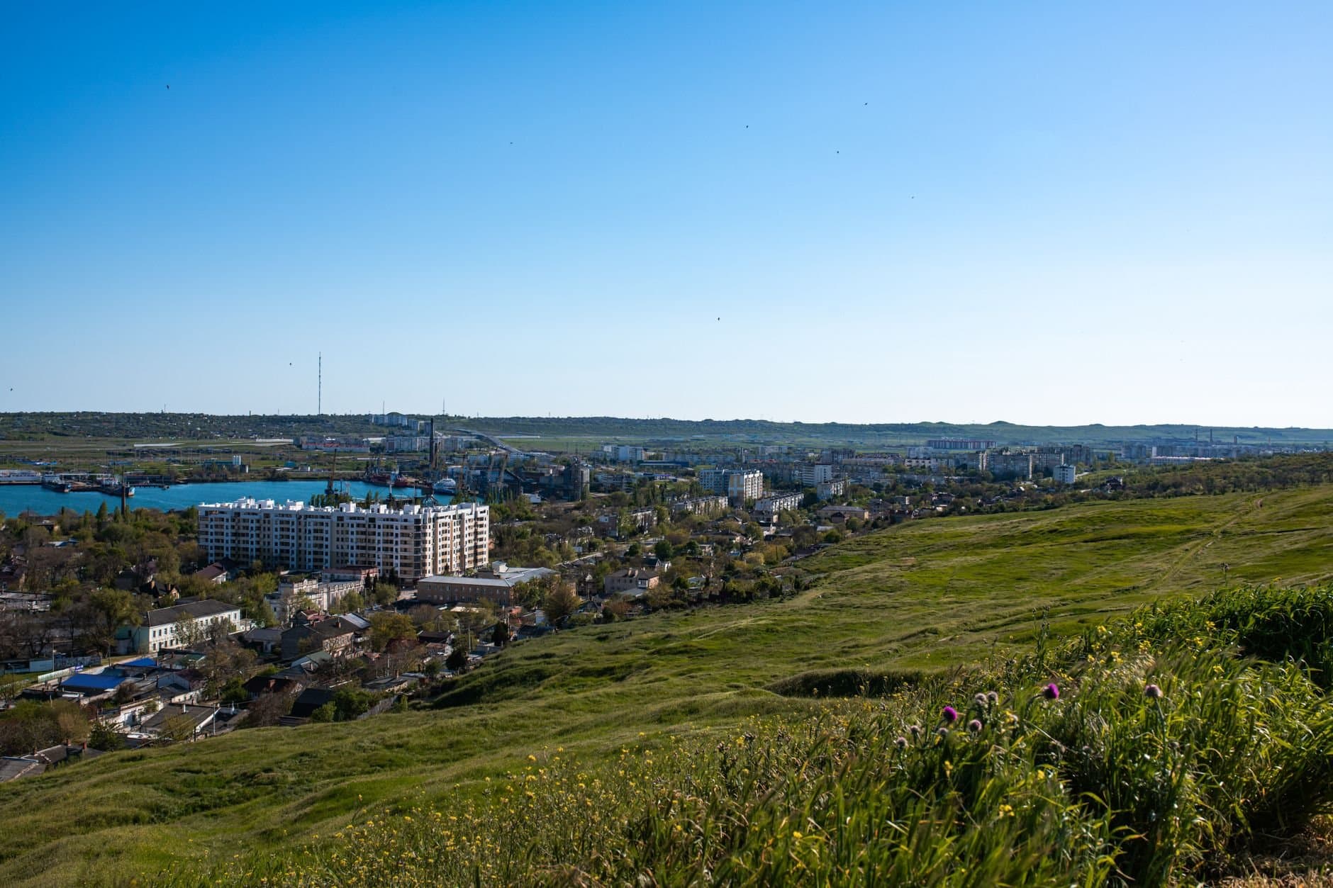 Breathtaking panoramic view of Kerch cityscape with lush green landscape and blue sky.