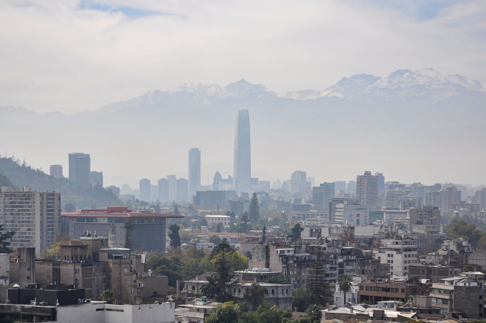 Panoramic view of Santiago's skyline with Andes mountains in the background.