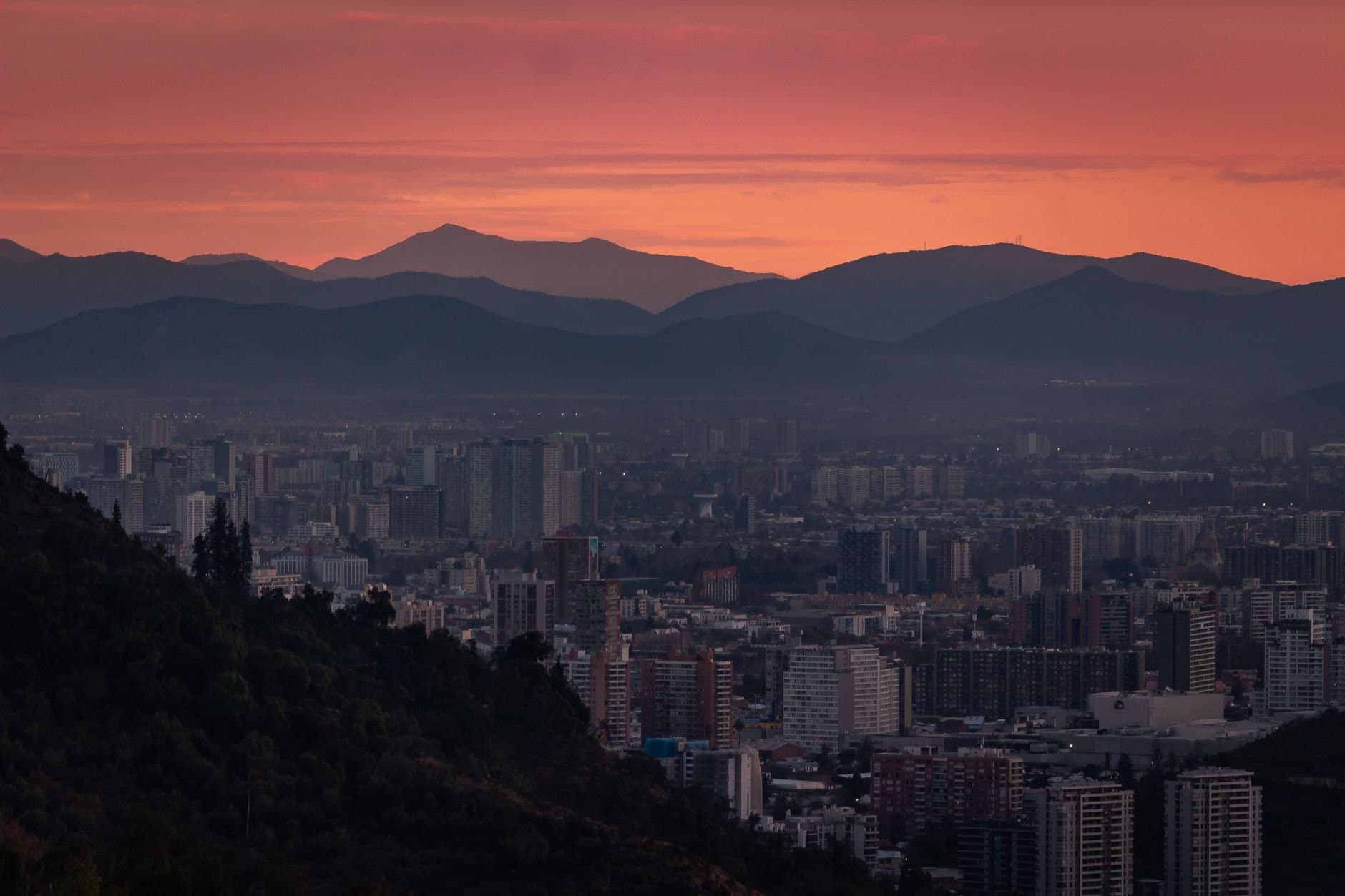 Spectacular dusk over Santiago's skyline with Andes mountains backdrop.