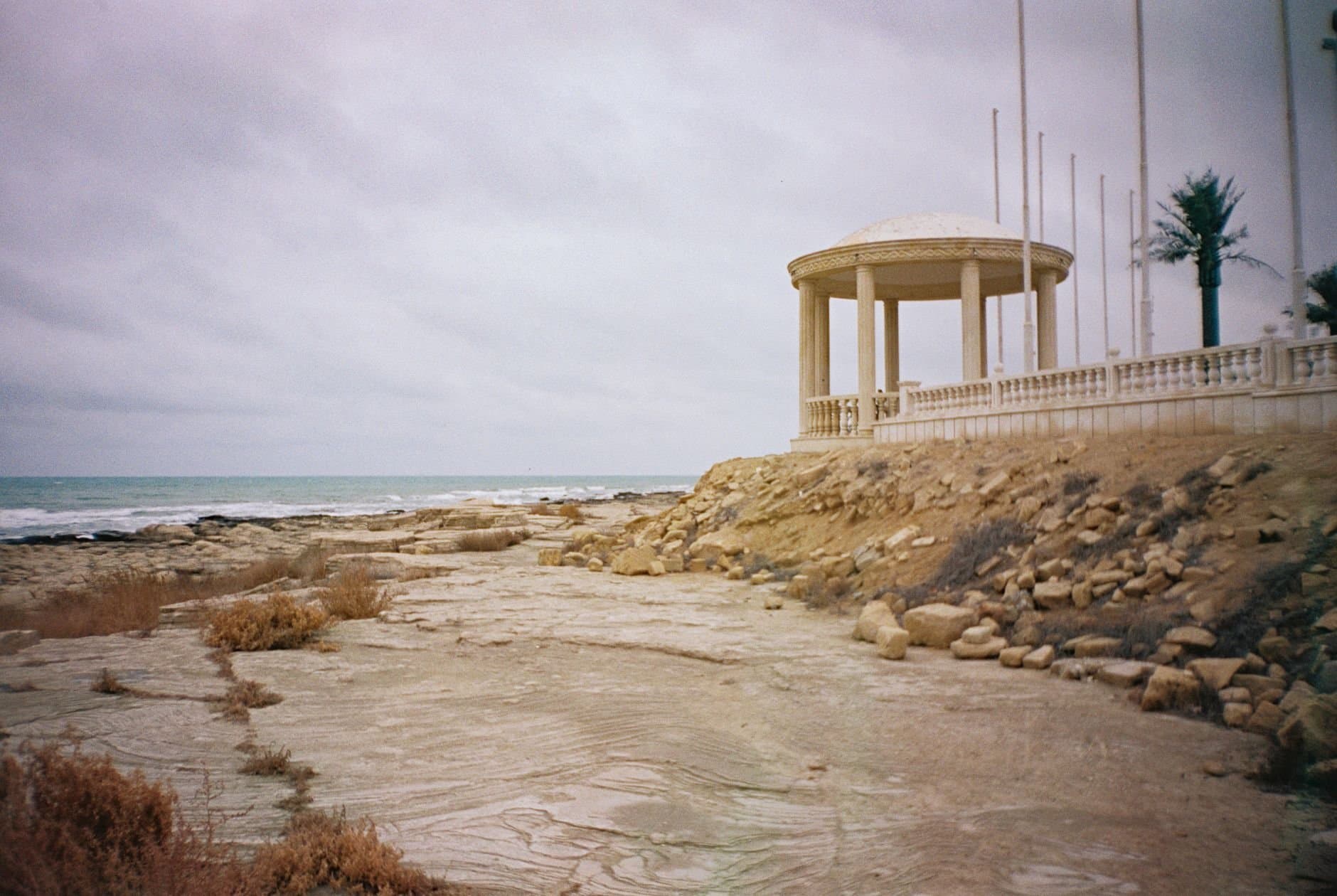 Serene coastal landscape in Aktau, Kazakhstan, featuring a picturesque gazebo by the shore.