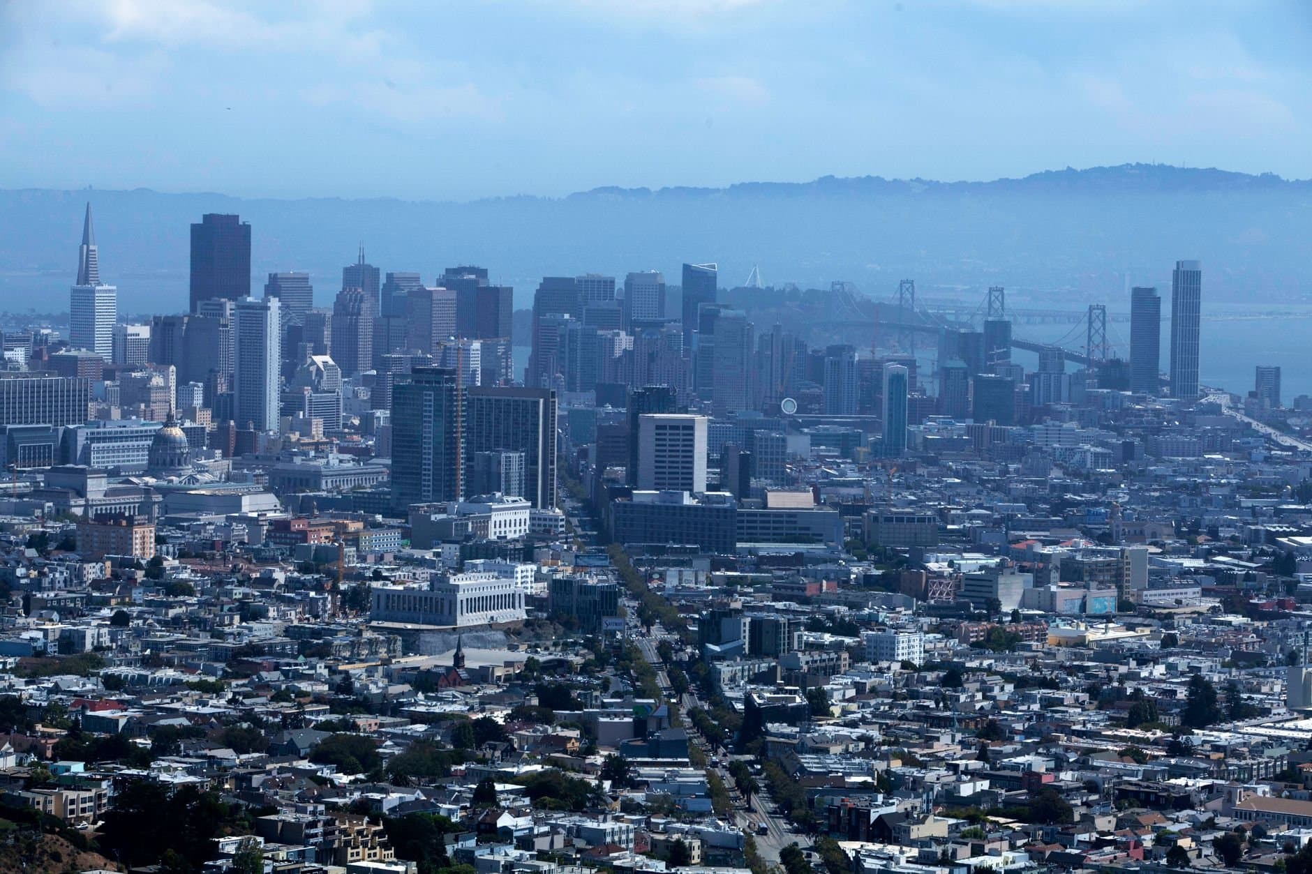 Stunning aerial view of San Francisco's skyline with iconic skyscrapers under a clear sky.