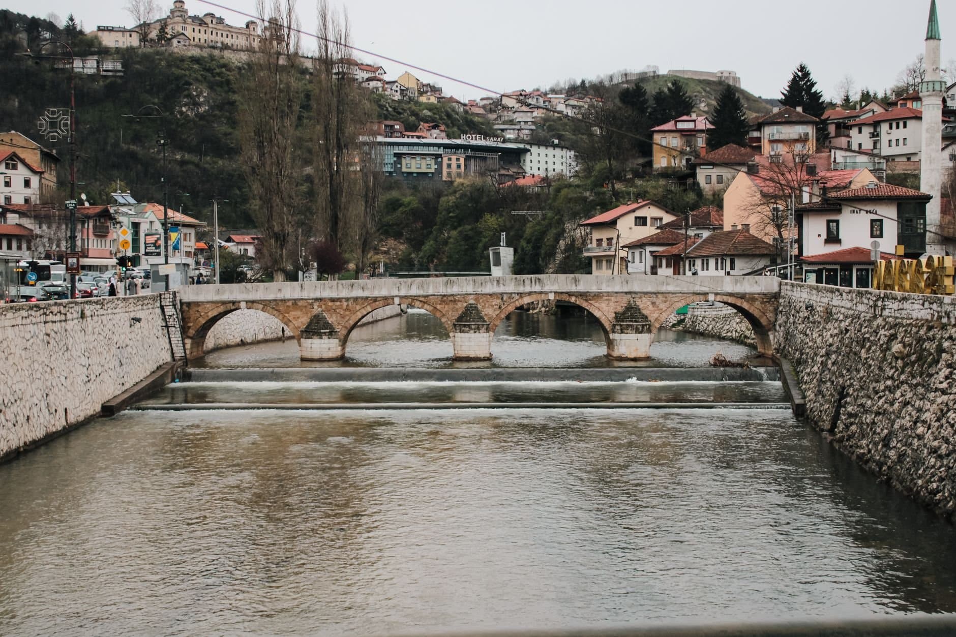 Scenic view of a historic stone bridge over the Miljacka River in Sarajevo, Bosnia and Herzegovina.