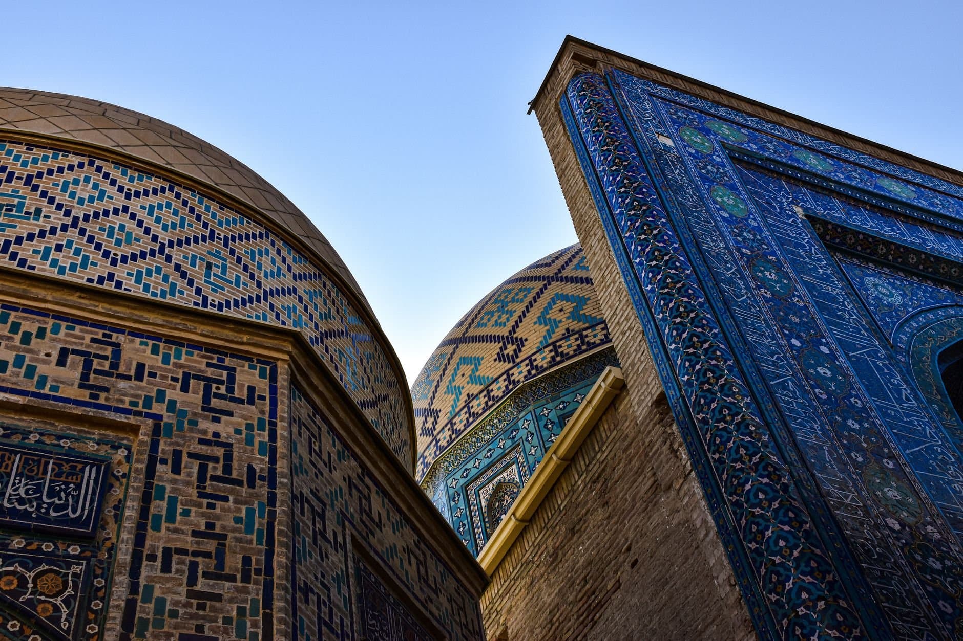 Explore the stunning mosaic patterns and domes of Shah-i-Zinda, a historic Islamic complex in Samarkand, Uzbekistan.