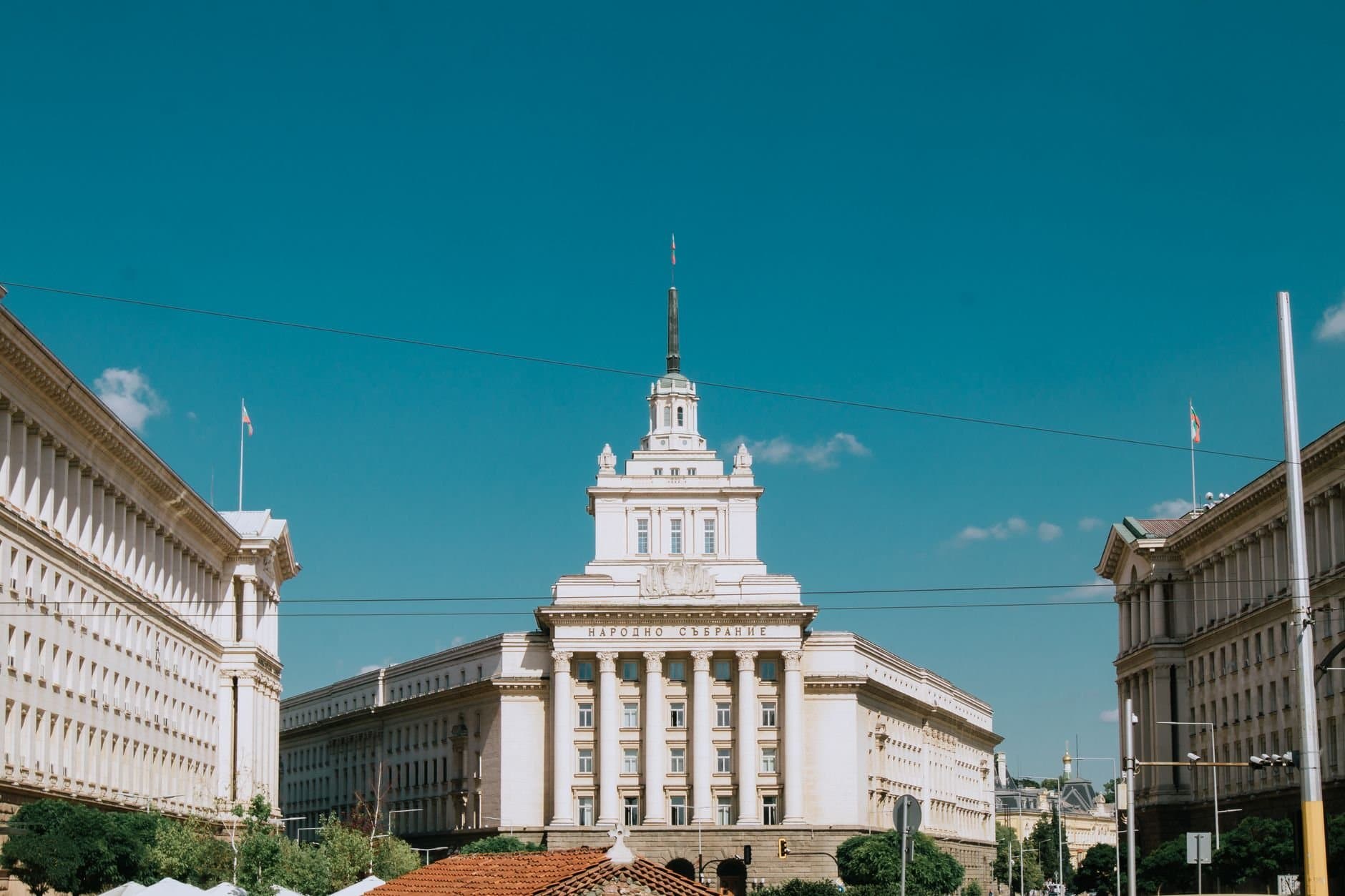 The National Assembly Building in Sofia, Bulgaria under a clear blue sky.