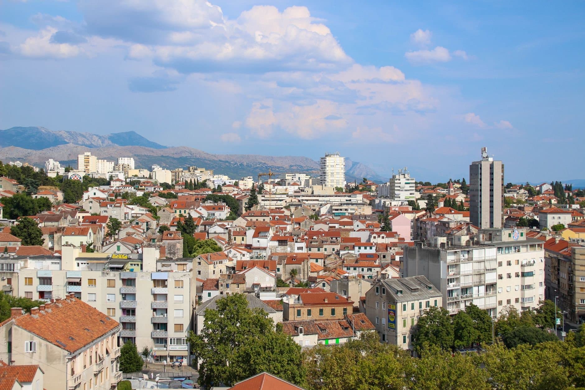 Aerial panoramic view of Split, Croatia showcasing urban architecture and distant mountains.