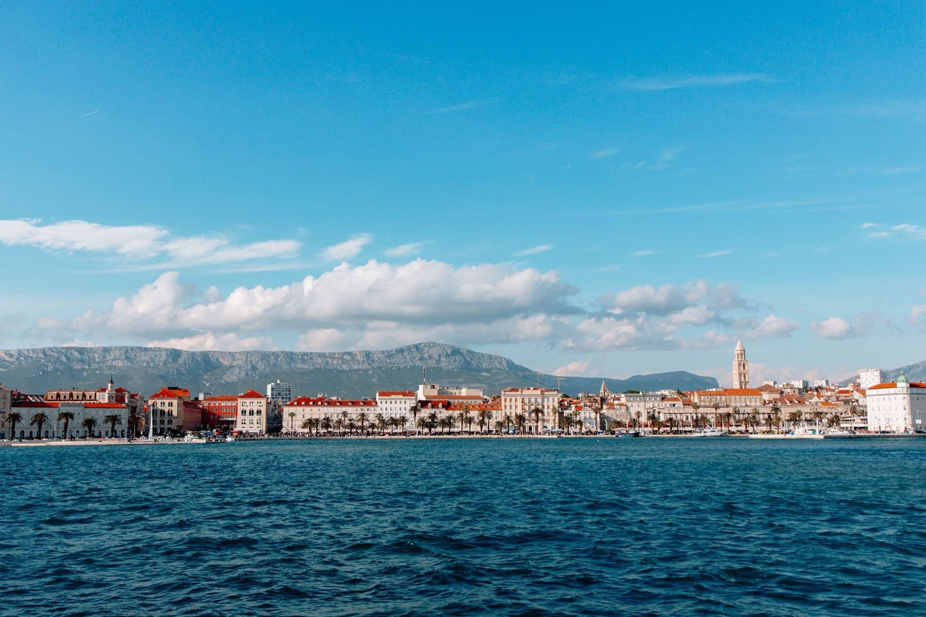 Discover the picturesque coastal cityscape of Split, Croatia, with its charming harbor and mountain backdrop.