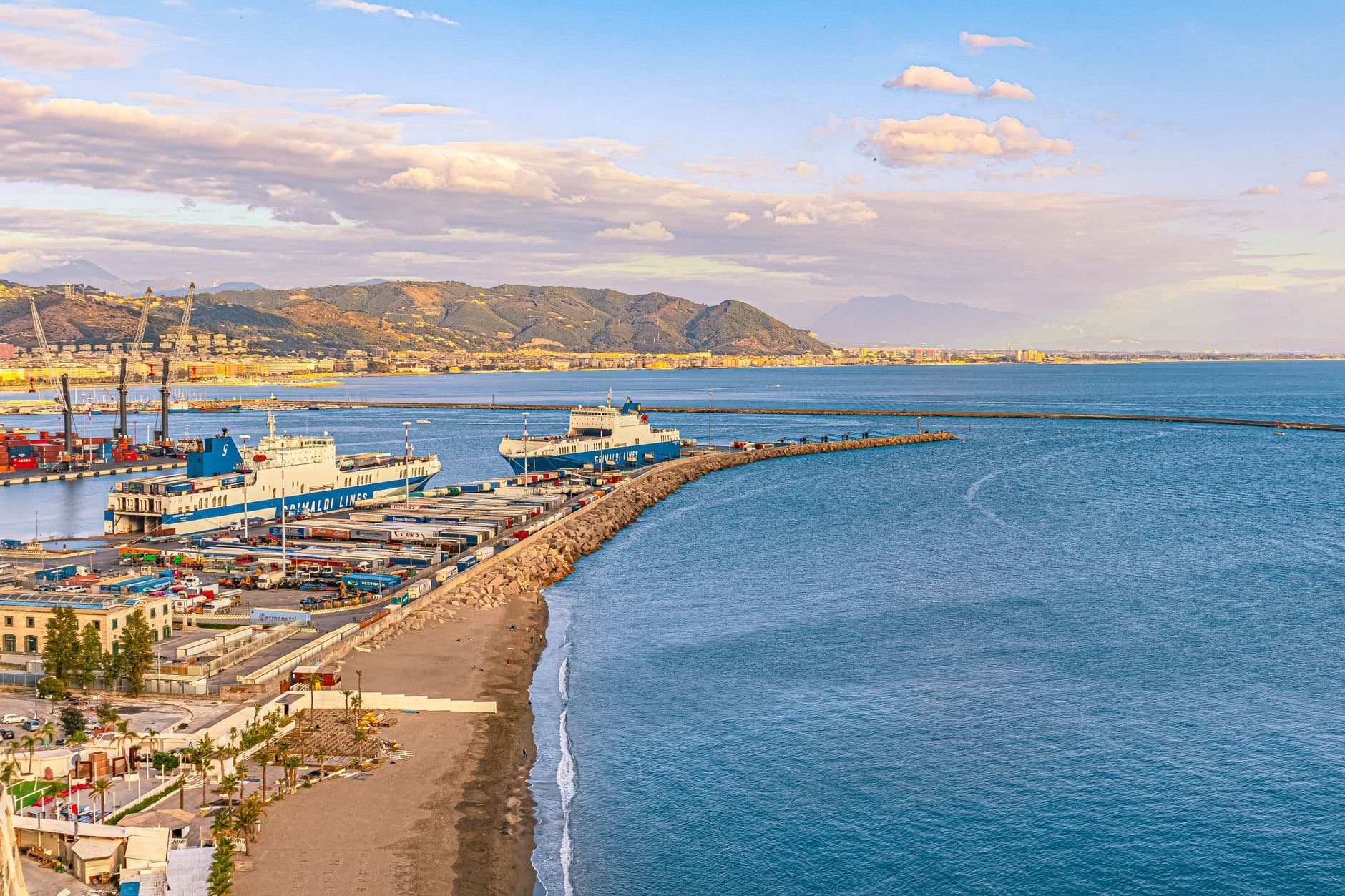 Aerial view of Vietri sul Mare harbor with ships and coastal landscape in Italy.