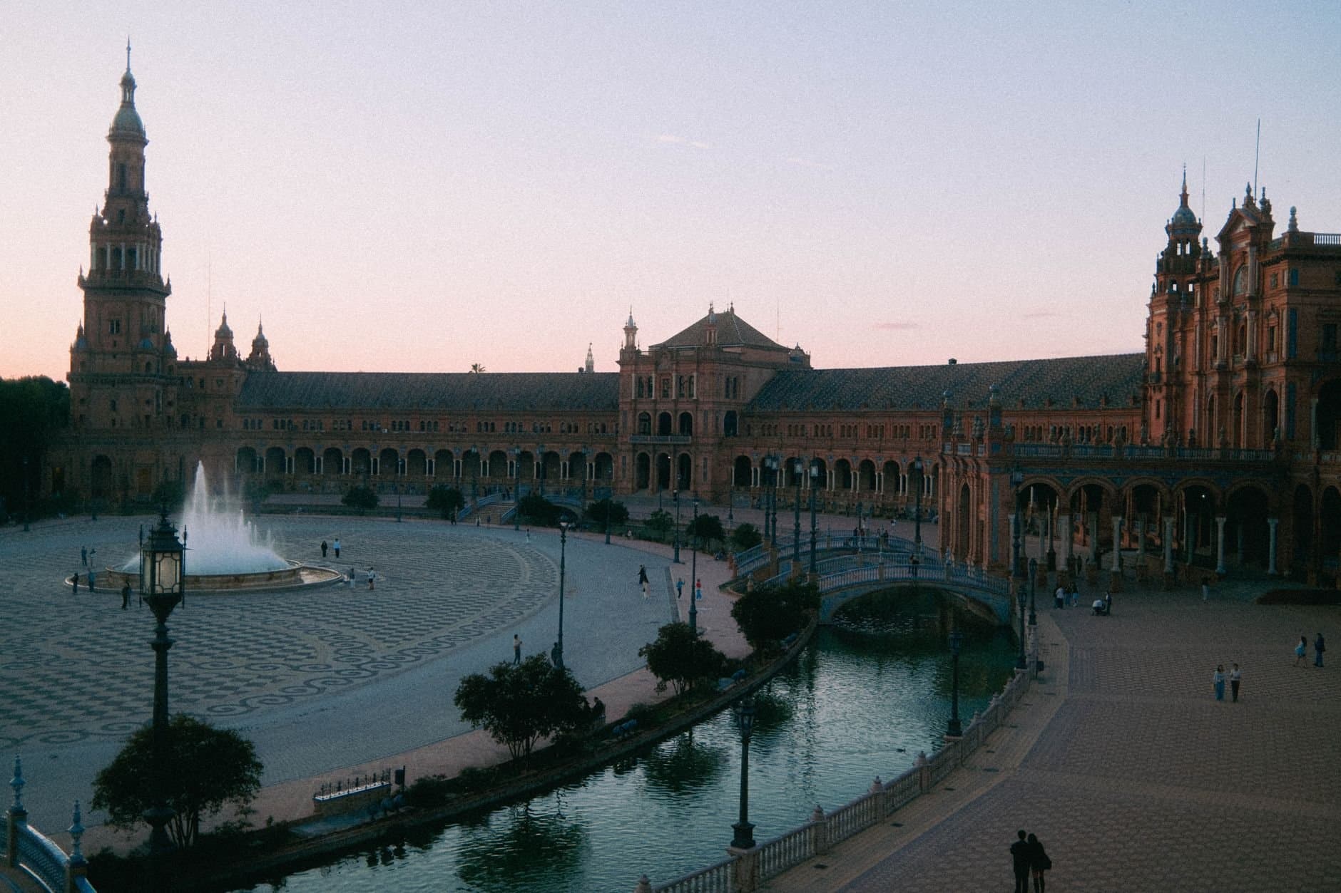 Capture of the iconic Plaza de España at twilight in Seville, showcasing its beautiful architecture and serene atmosphere.