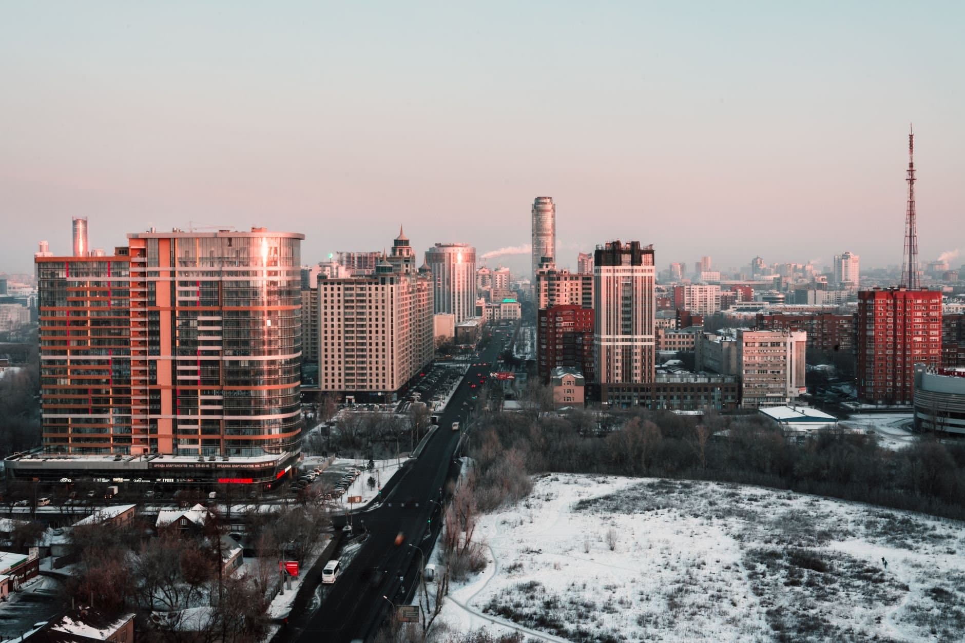 Aerial view of Yekaterinburg's skyline during winter, showcasing modern skyscrapers and snow-covered urban landscape.