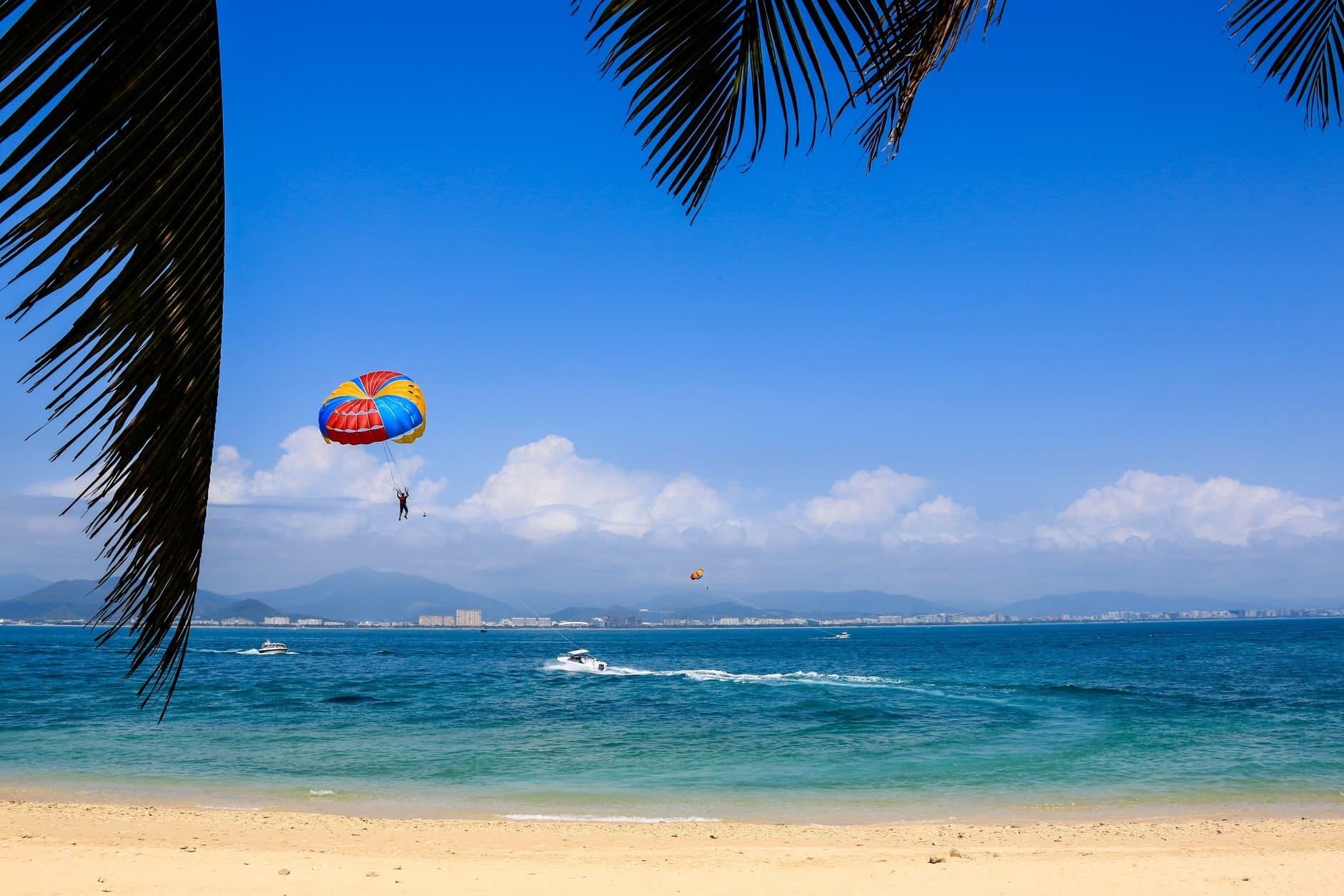 Enjoy thrilling parasailing on a sunny day in Sanya, China's tropical seaside paradise.