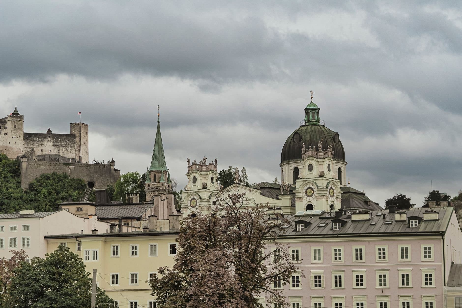 Explore the architectural charm of Salzburg's Dom Quartier with Hohensalzburg Fortress in the backdrop.