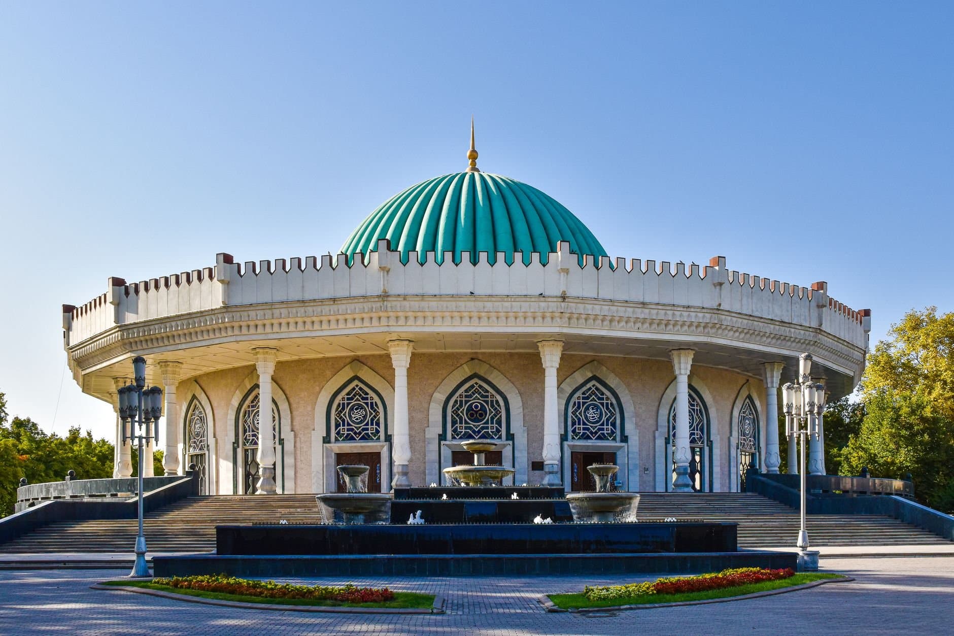 Beautiful exterior of the Amir Timur Museum featuring a striking turquoise dome in Tashkent, Uzbekistan.