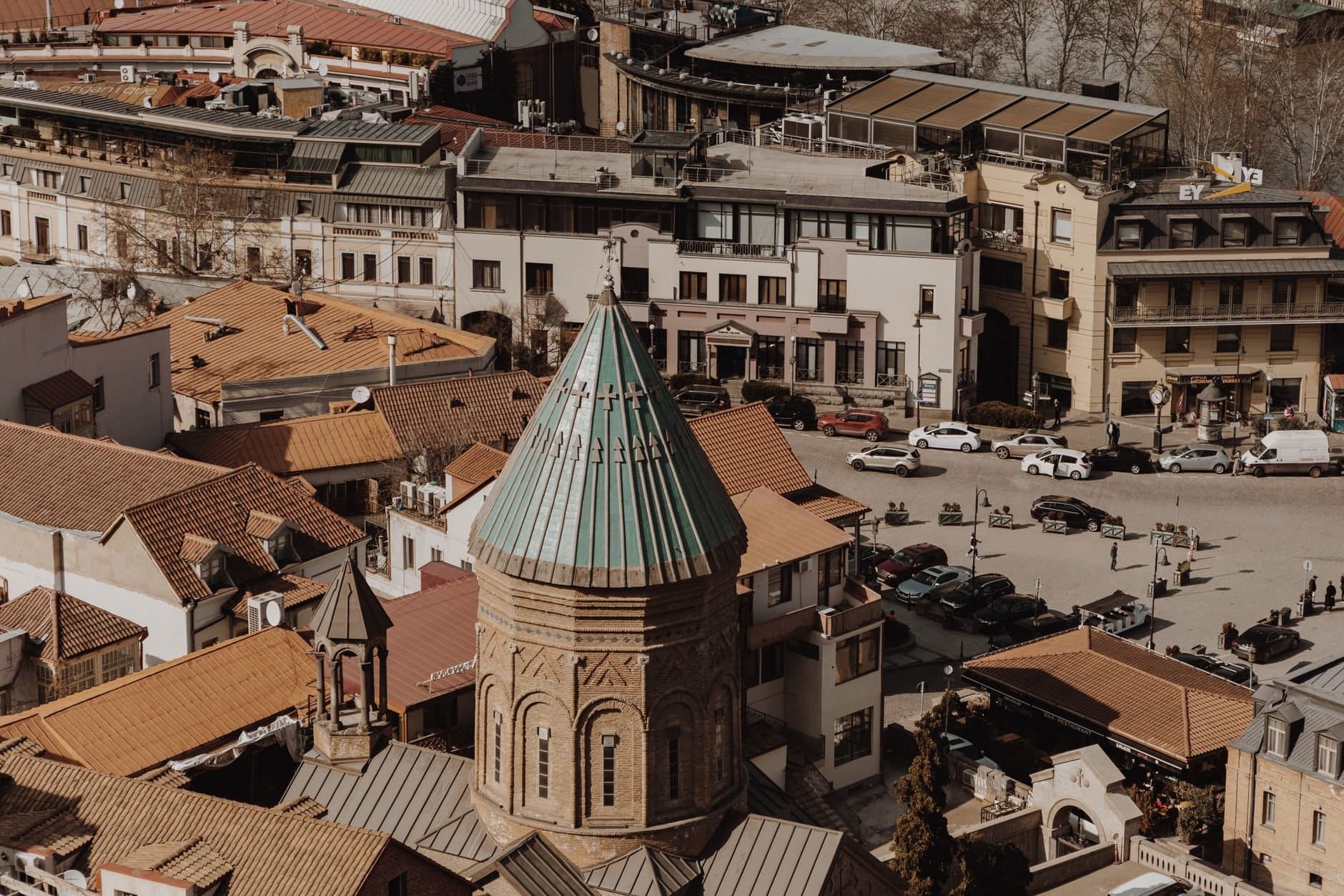 Aerial view of old town Tbilisi showcasing historic architecture and city life.