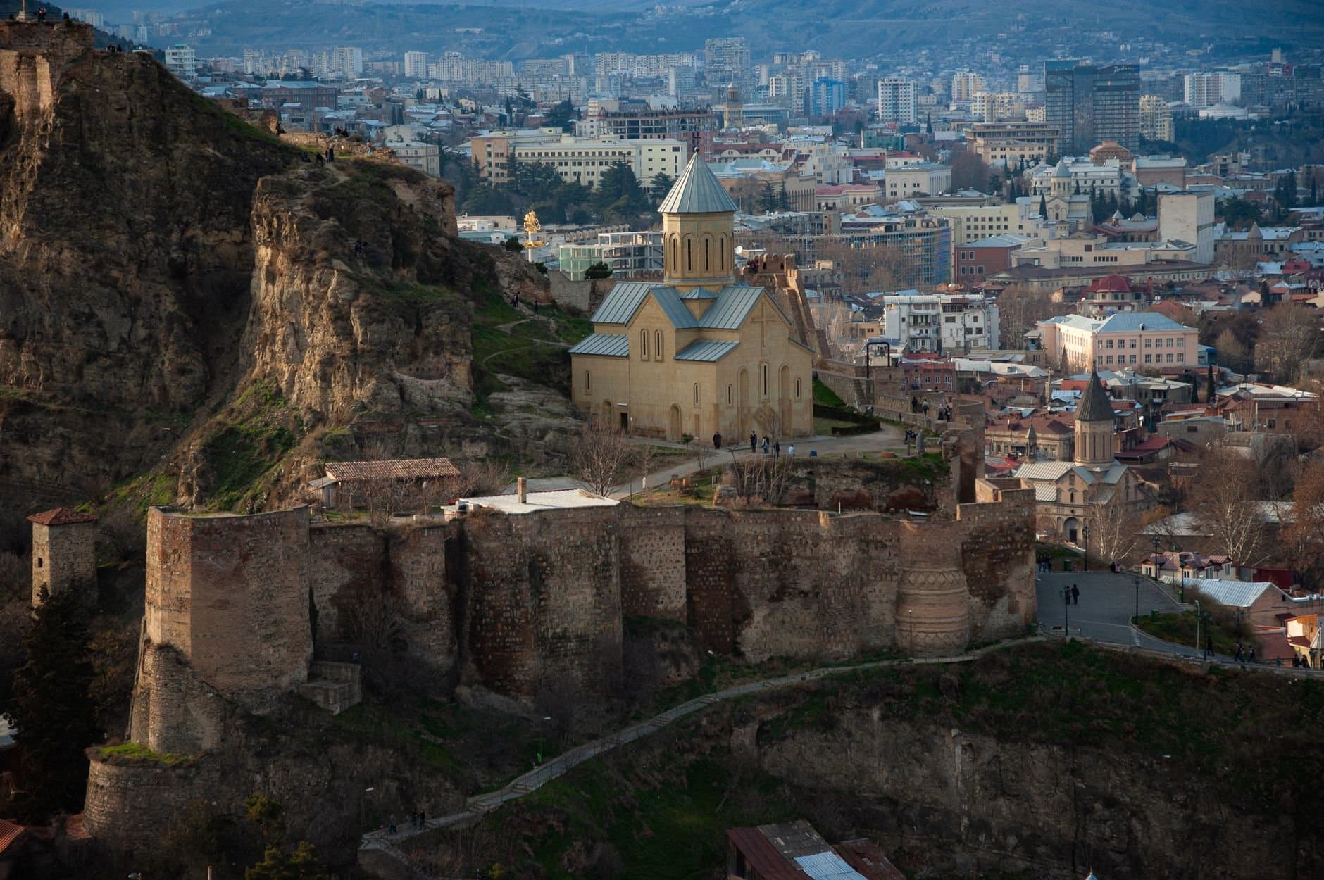 Aerial photograph of Tbilisi's historic church against a backdrop of the cityscape.