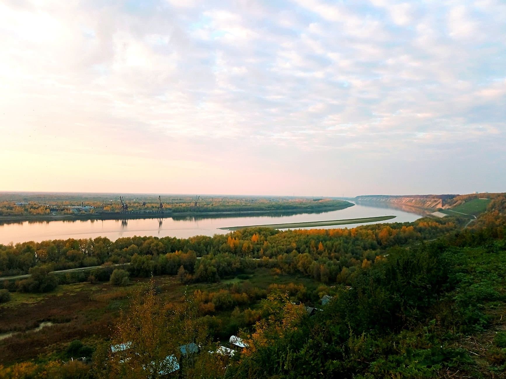 Peaceful dusk view of the river bend and vibrant autumn foliage in Tobolsk, Russia.